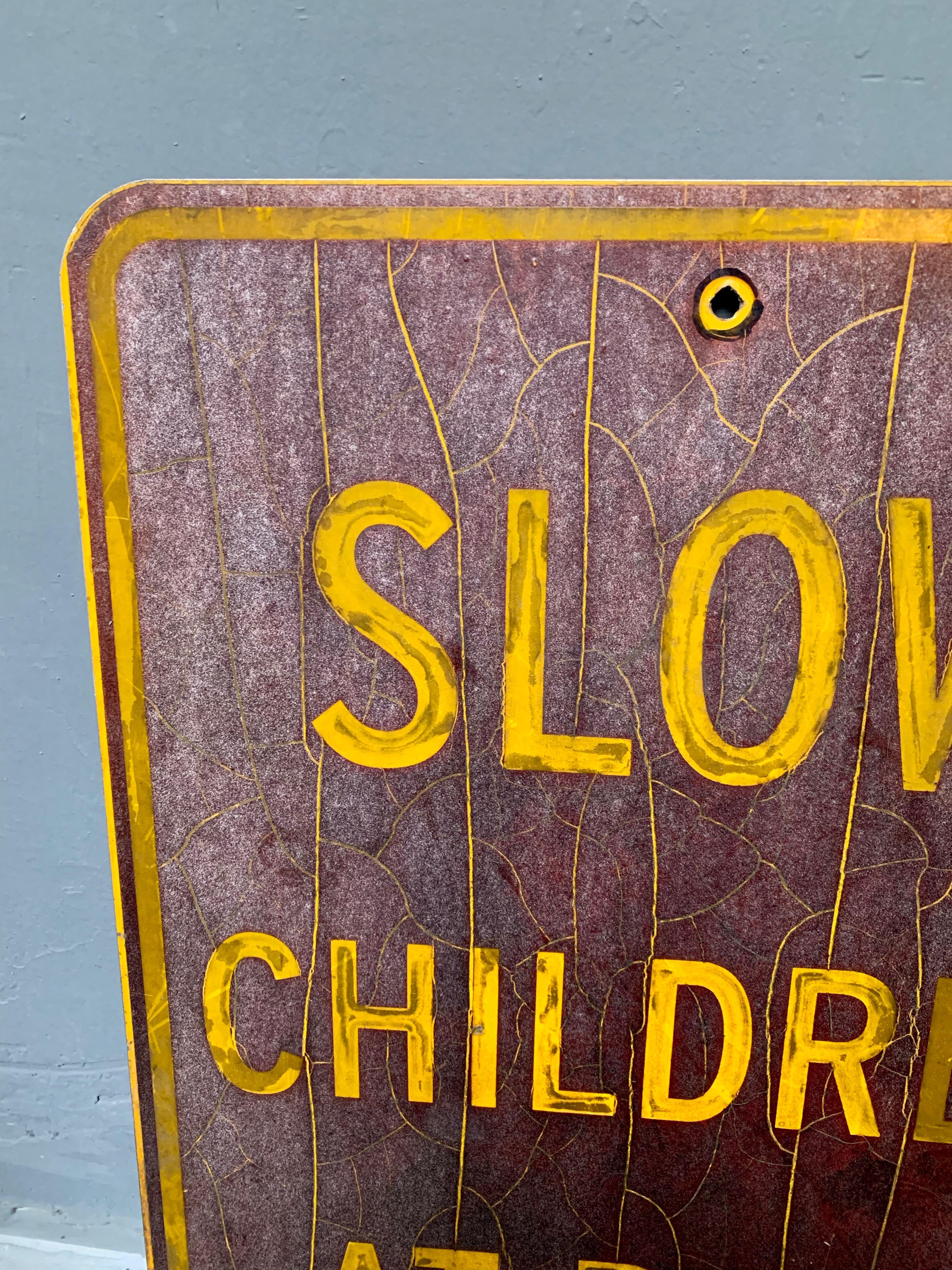 Vintage Los Angeles ‘Slow Children at Play' sign. Brown background with yellow lettering. Great coloring and patina. Perfect for a kid's room.