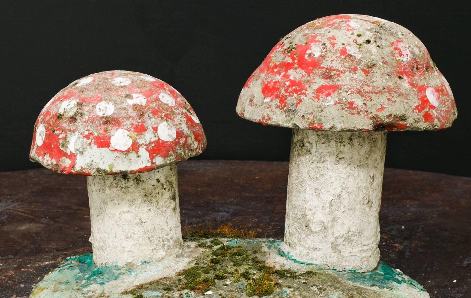 Charming, small hand-painted concrete toadstool garden sculpture.