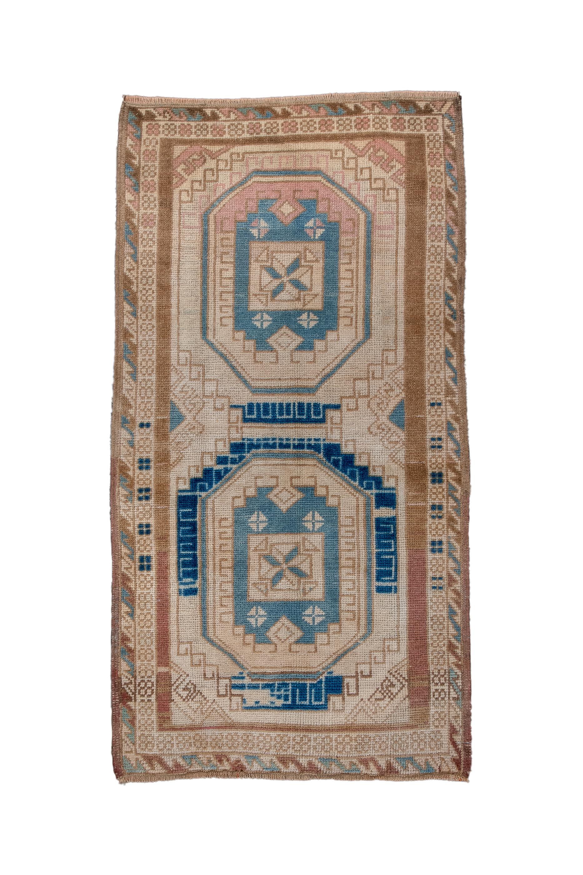 This ruglet shows a cream field with two large octagonal medallions, each enclosing a doubly indented panel.  Stepped outlines for each medallion. Hooked, secondary motives at sides and corners of field. All wool, moderate weave. Royal blue and teal