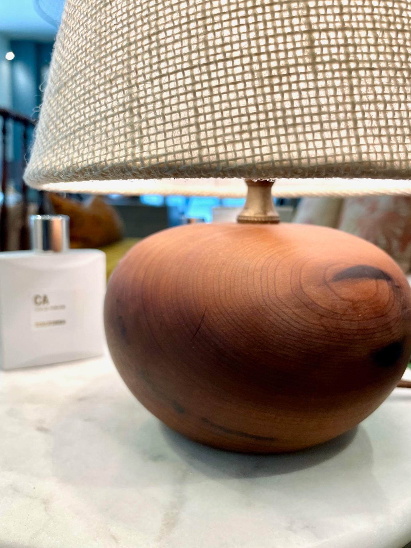 This small vintage round ’ball’ teak lamp is a bold but tastefully understated accent for that special spot that needs a little light. It has been newly rewired and has a new custom burlap shade and will be a handsome addition to any table or