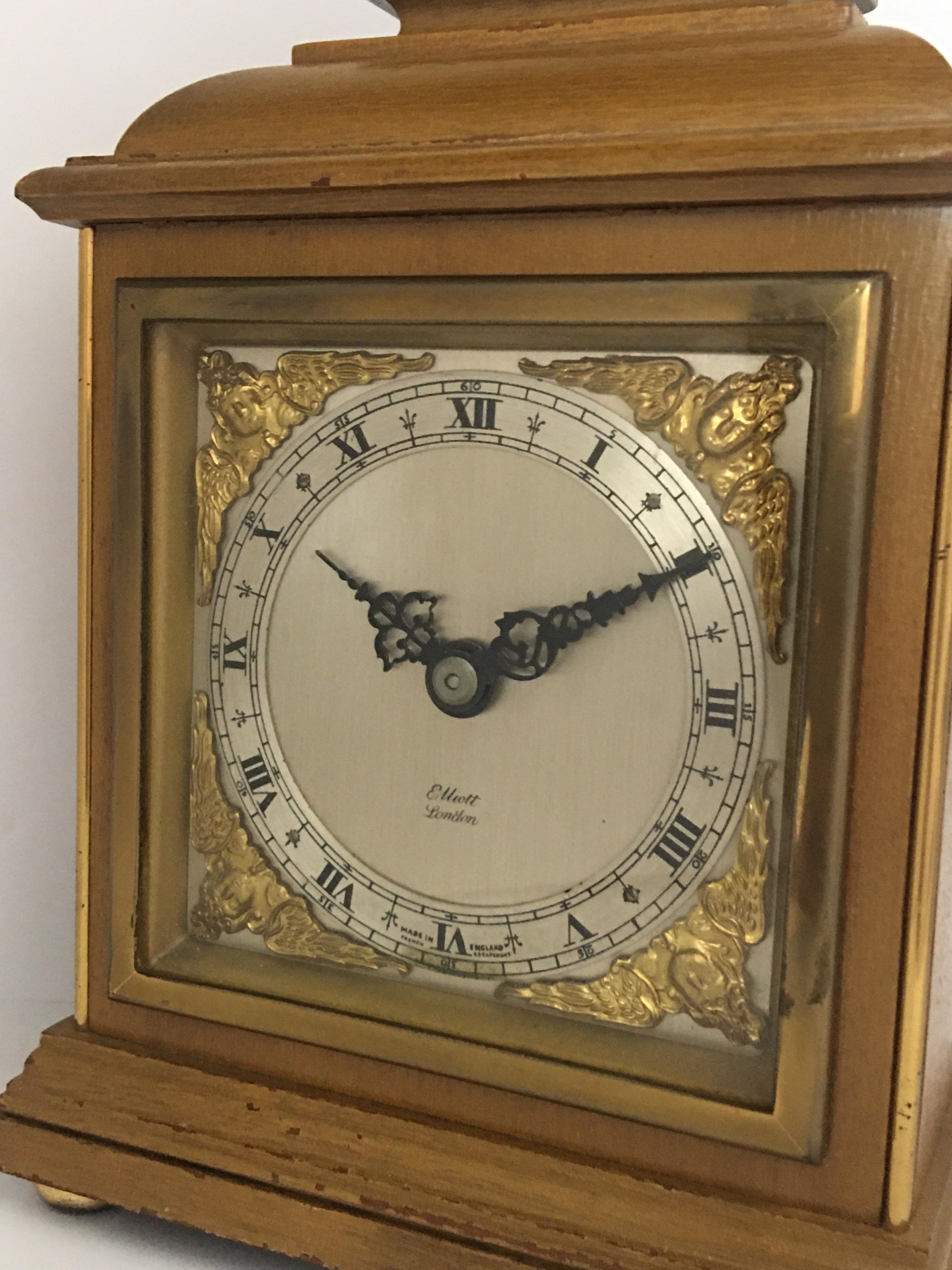 This beautiful 8th day mechanical English mantel clock is in good working condition and it is running well. Signed by Elliot London. Visible signs of ageing and wear with tiny light marks on the wooden case as shown. Please study the images