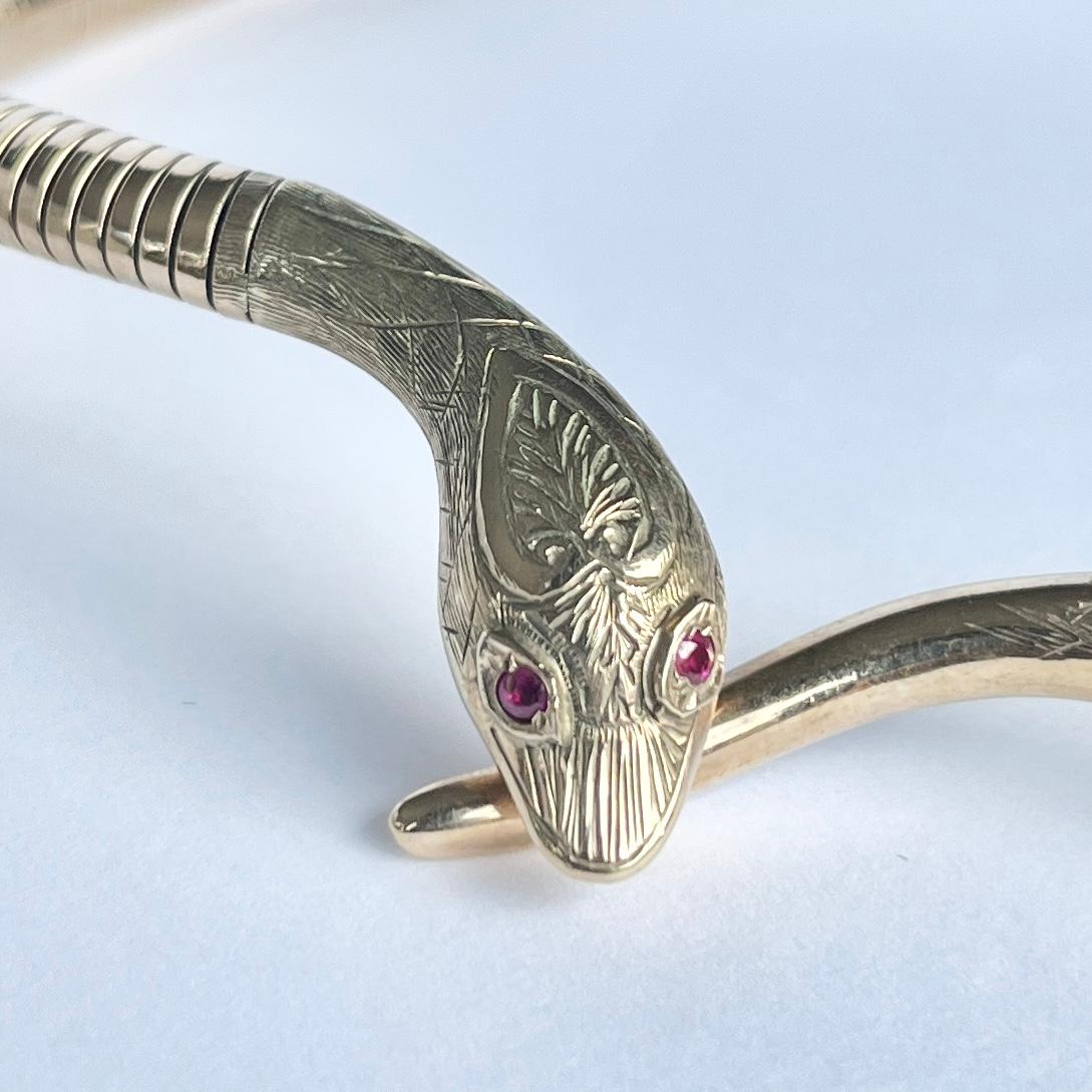 This stunning Smith & Pepper necklace is modelled in 9 carat gold. The absolutely gorgeous little face features two 4pt ruby eyes and delicate engraving. The style of the pieces really mimic the movement and the feel of a coiled snake. 

Necklace