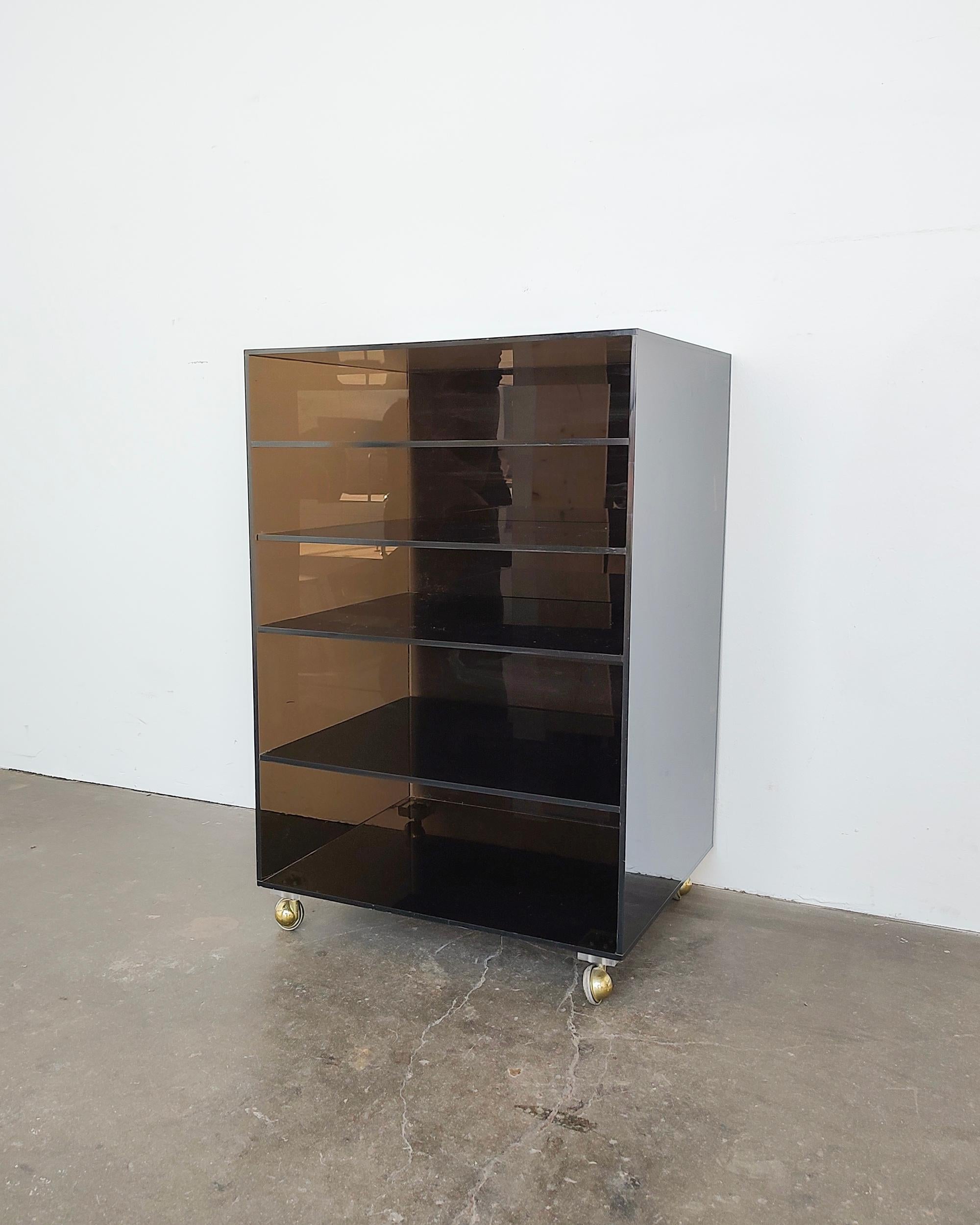 Vintage smokey acrylic cart circa 1970s. Brass-plated satellite casters and five divided compartments perfect for organizing. Overall good condition, light scratches on the top, wear on the caster rollers.

17