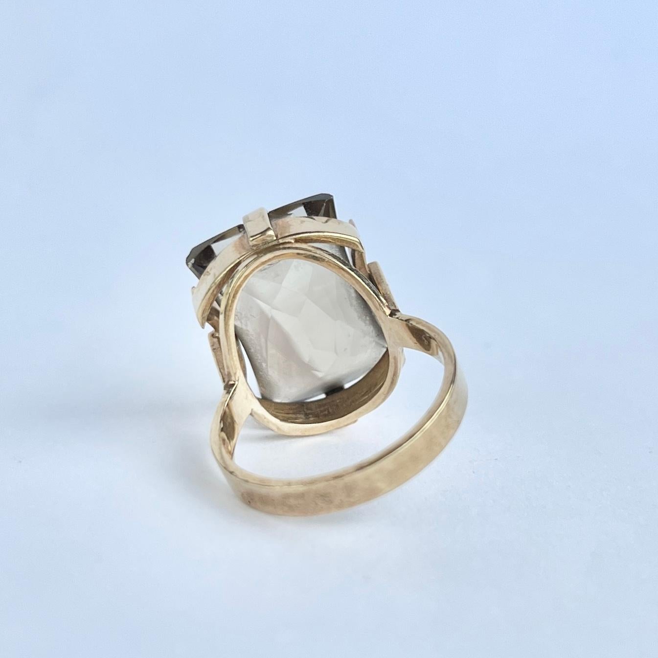 The smokey quartz stone in the ring is large and gorgeous! It is deep in colour and held by simple claws on a modernistic gallery and shank. The ring is modelled in 9carat gold. Fully hallmarked London 1969.

Ring Size: N 1/2 or 7
Stone Dimensions: