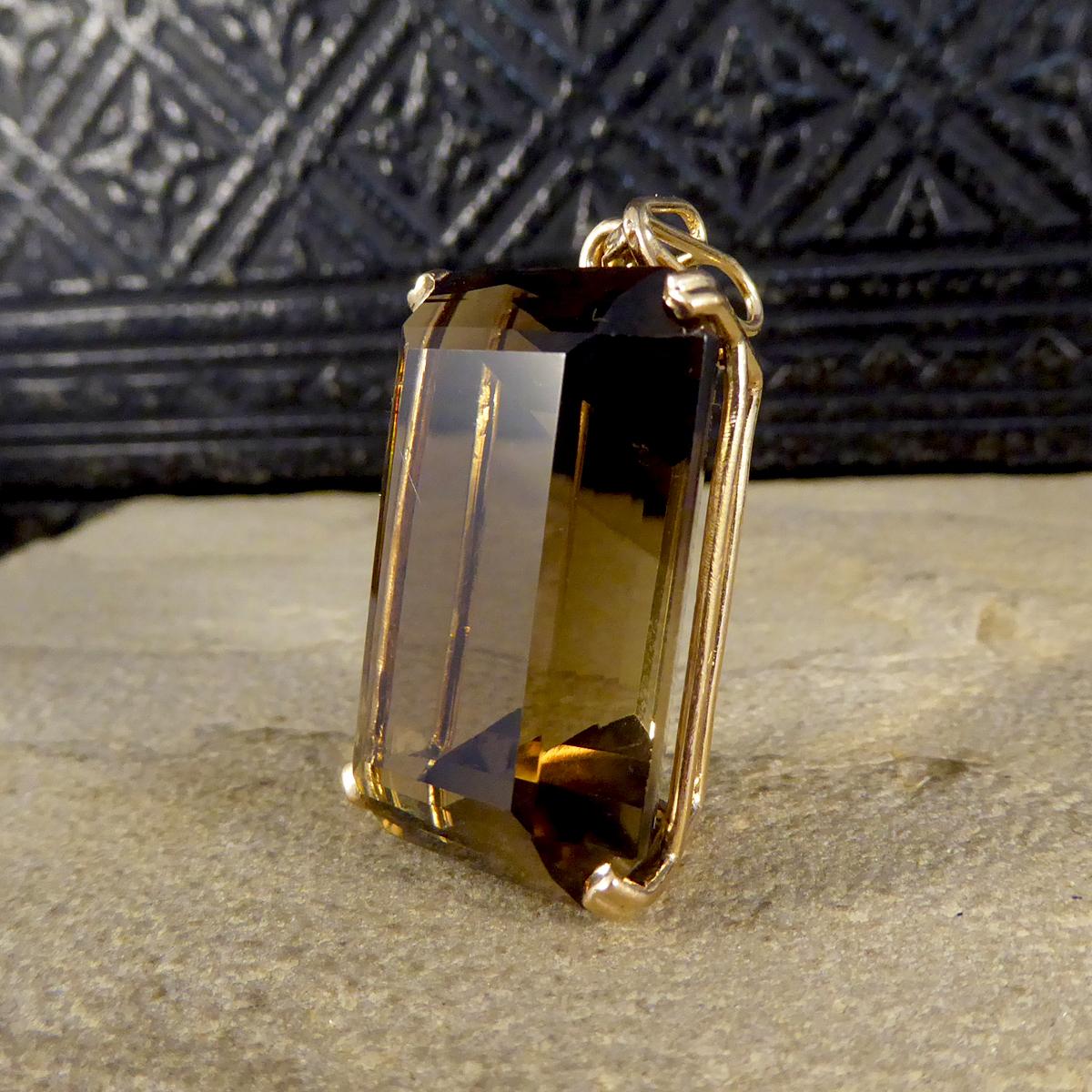 This lovely vintage pendant has been crafted from 14ct Yellow Gold with clear stamps on the settings. The pendant features a single Smokey Quartz stone in a four double claw setting and have lovely deco style bail so a chain can be attached to wear