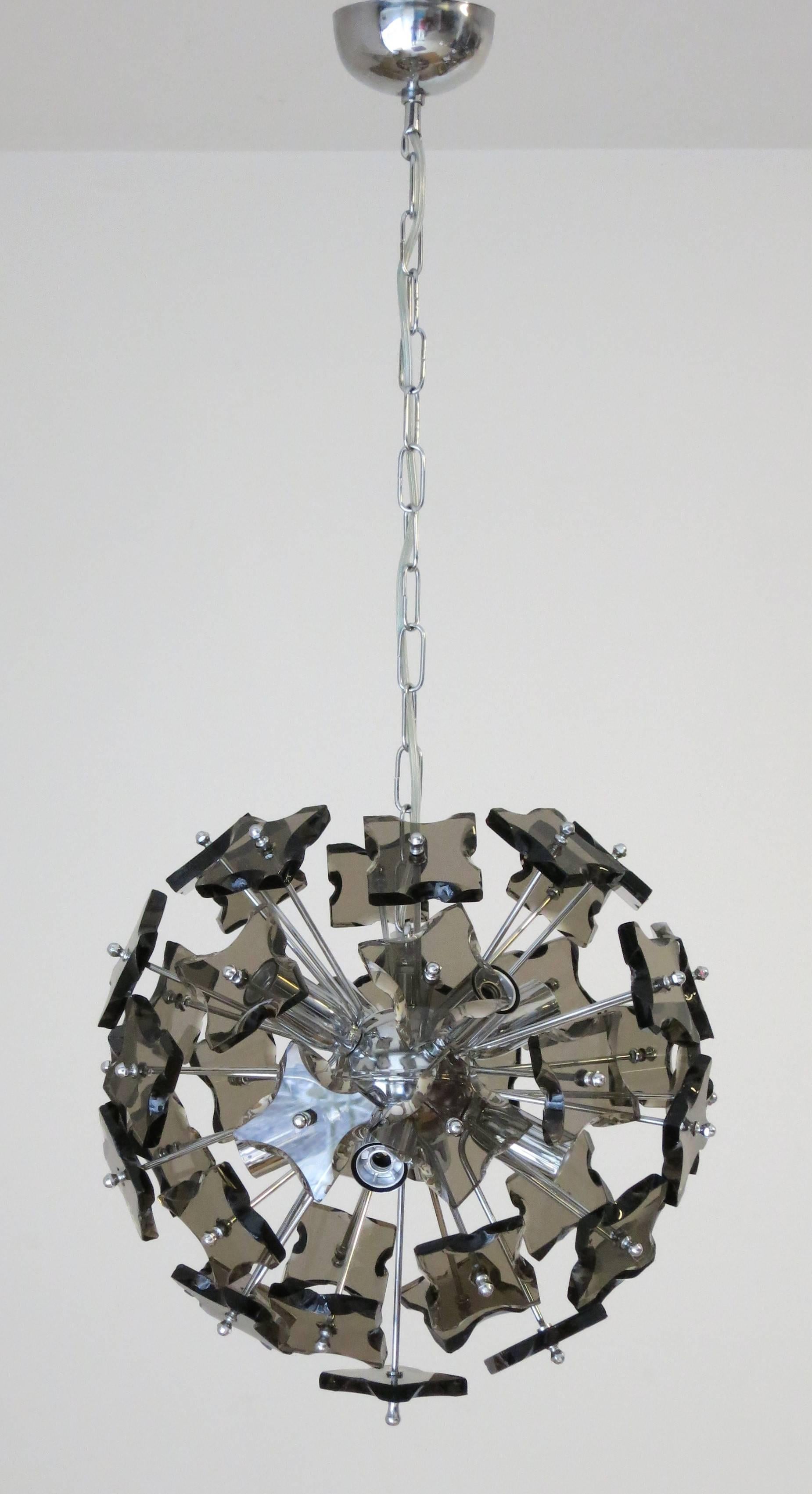 Original vintage chandelier with blown smoky Murano glasses and hand chipped edges, mounted on nickel plated metal frame / In the style of Fontana Arte / Made in Italy circa 1960’s
8 lights / E12 or E14 type / max 40W each
Diameter: 16 inches /