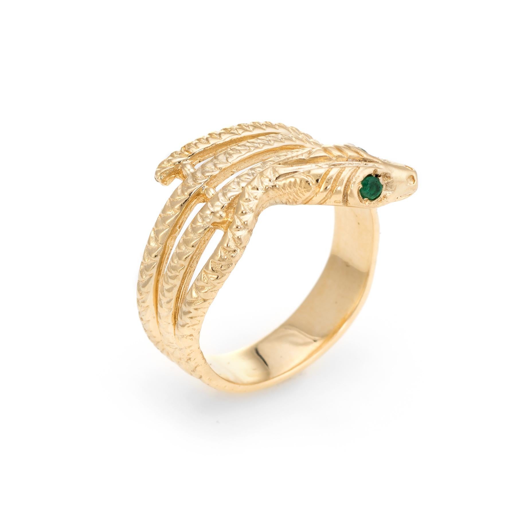 Finely detailed vintage snake ring, crafted in 18 karat yellow gold. 

Two estimated 0.01 carat emeralds adorn the snakes eyes (total estimated weight of 0.02 carats).      

For centuries the snake has represented eternal love and faithfulness. The