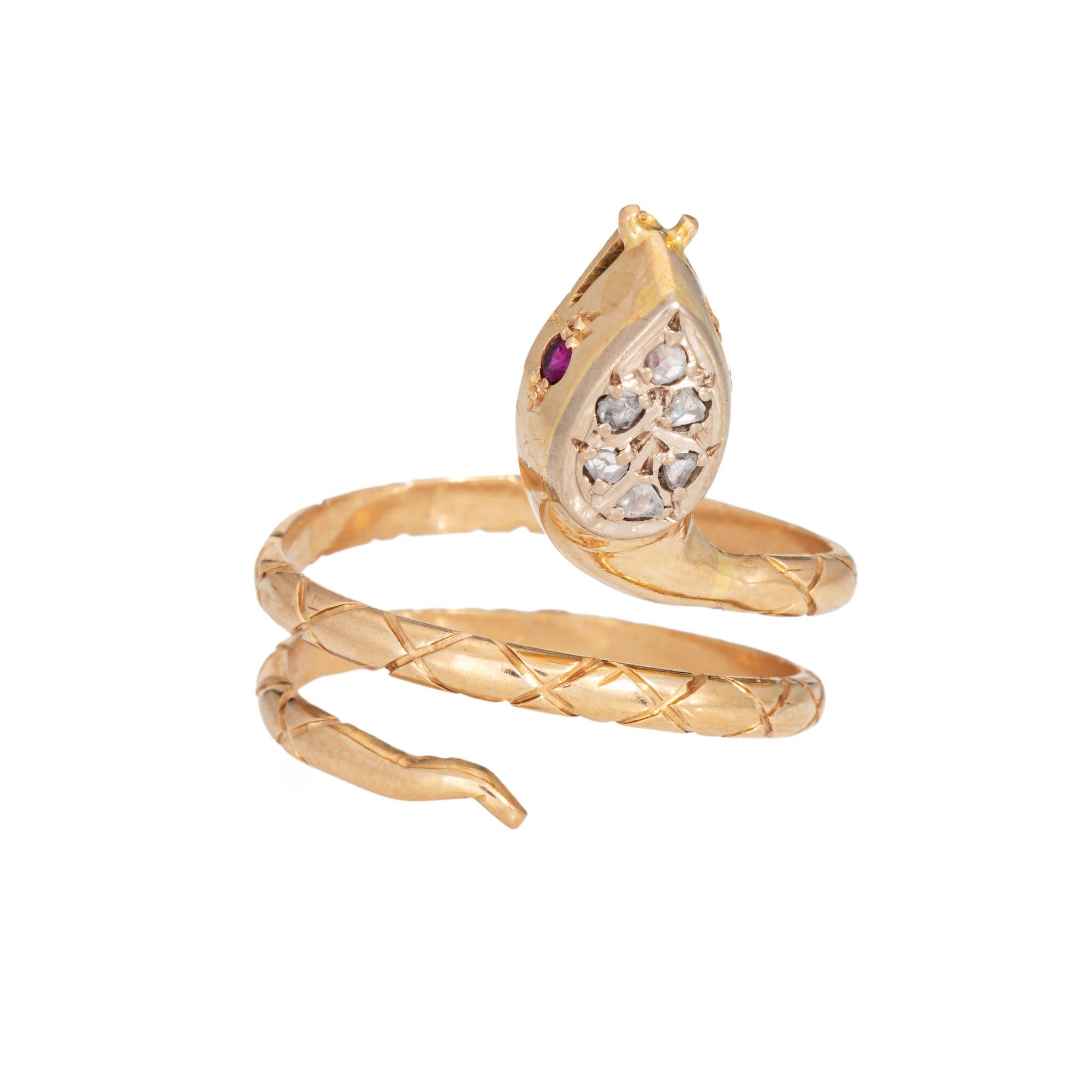 Finely detailed vintage snake ring crafted in 18 karat yellow gold (circa 1970s to 1980s). 

Old rose cut diamonds total an estimated 0.06 carats. 2 small rubies are set into the snakes eyes.      

For centuries the snake has represented eternal