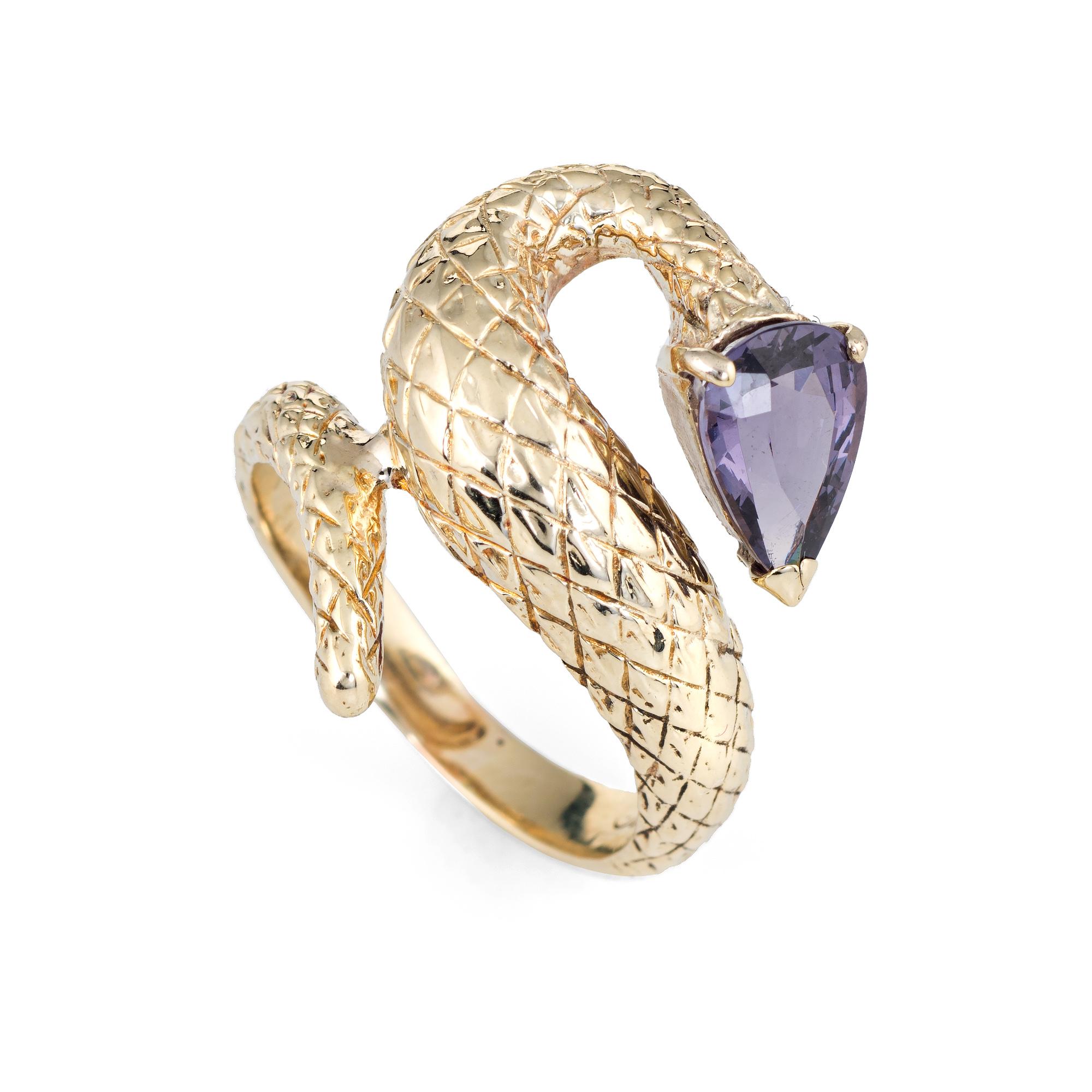 Finely detailed vintage snake ring crafted in 14 karat yellow gold.

Pear cut purple spinel measures 10mm x 6.5mm (estimated at 2.50 carats). The spinel is in excellent condition and free of cracks or chips. 

The sinuous snake sits nicely on the