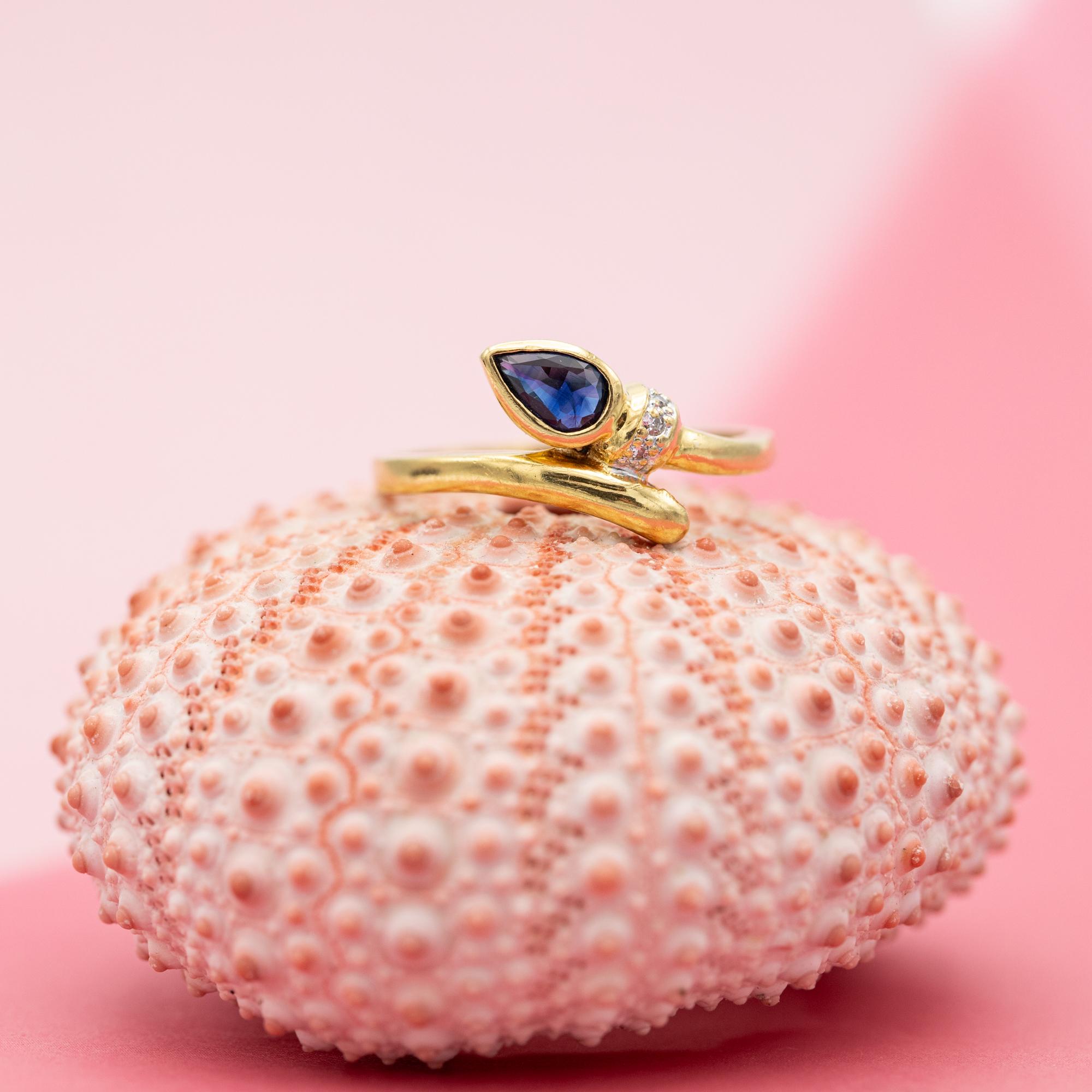 For sale is this stunning 18 ct yellow gold snake ring. It's head is made out of a pear shaped sapphire while three small single cut diamonds bring the snakes to live, we adore the details in this ring. This ring is most likely crafted in the late