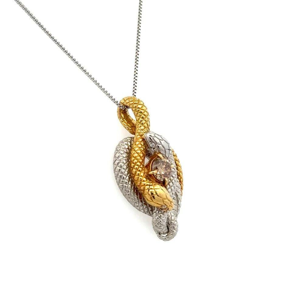 Simply Beautiful! Featuring a Coiled Serpent Snake Platinum and Yellow Gold Pendant Necklace. Centering a Securely Hand set Coffee Diamond, weighing approx. 0.50 Carat in a Coiled Serpent surround. Finely Hand crafted in Platinum and 18 Karat Gold.