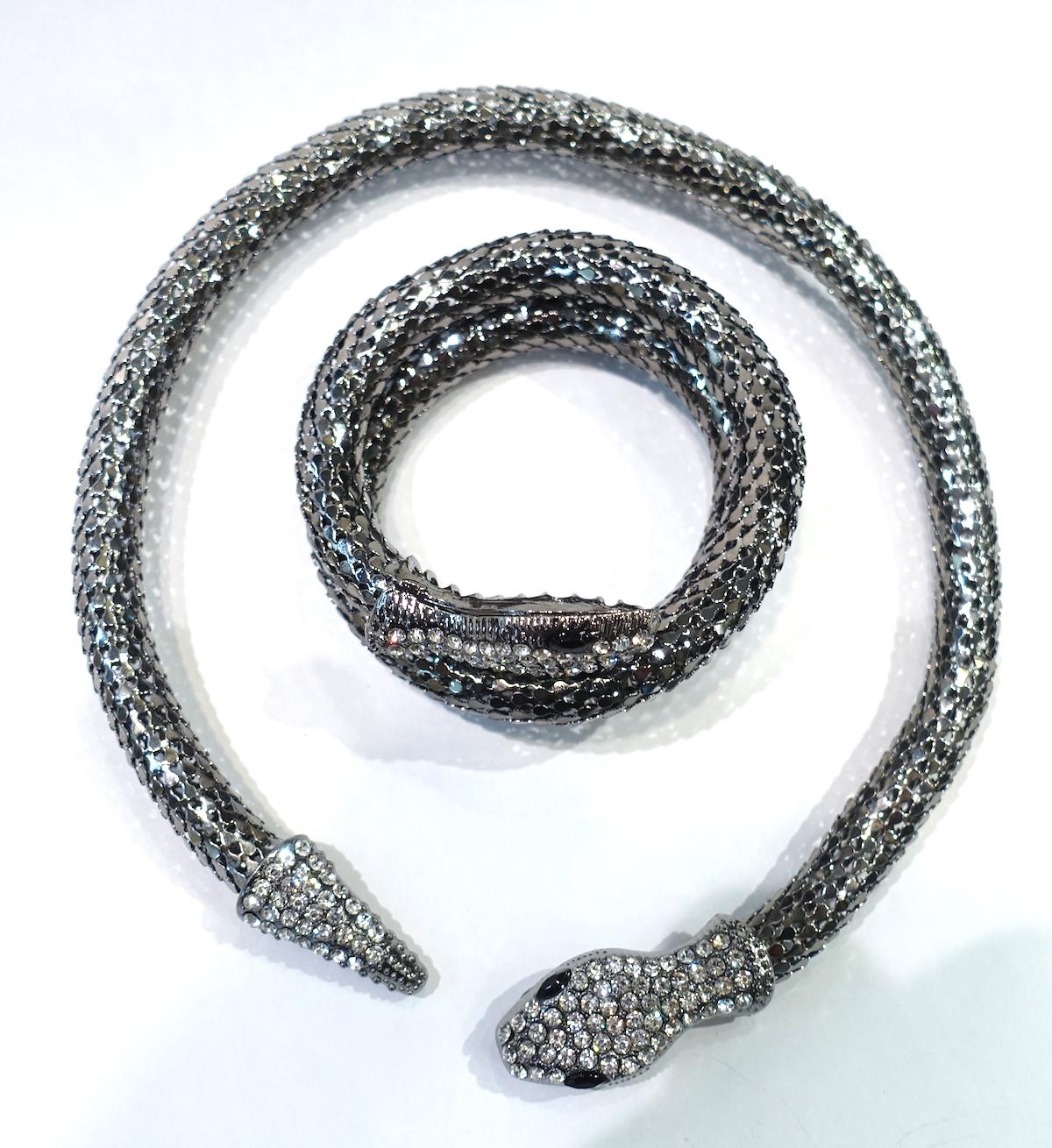 This vintage set features a snake design with black and clear crystals in a silver tone setting.  The wrap bracelet measures 14” x 5/8”; the necklace is 16-1/2” x 5/8”.  This vintage necklace & bracelet set is in excellent condition.