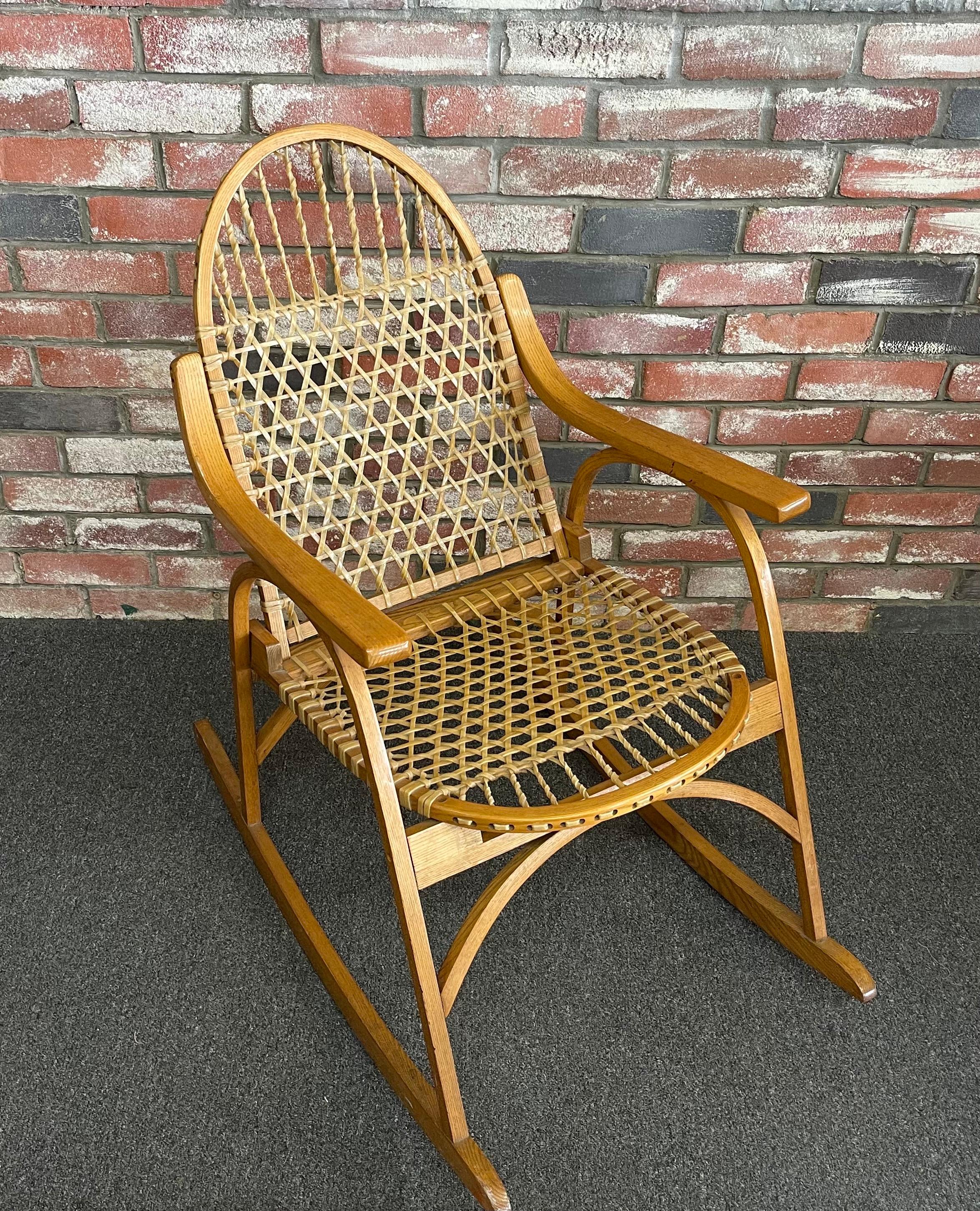 Vintage snowshoe oak & rawhide rocking chair by Vermont Tubbs, circa 1960s. The rocker is very sturdy and is in good vintage condition with no cracks or breaks to the rawhide. Super cool piece! #1674

Dimensions: 34.25