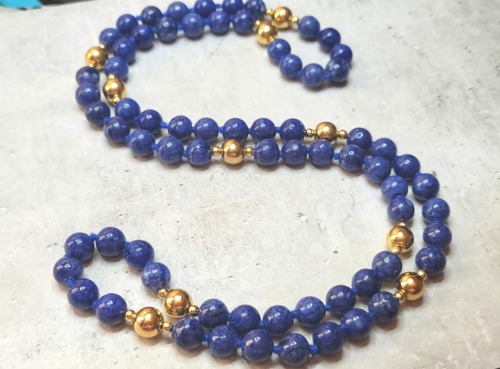 The length of the necklace is 30 inches (76 cm).
The size of the smooth round sodalite beads is 8 mm, the size of the large 14K gold beads is 7.7 mm, and the small 14K gold beads are 3mm.
The beads are not a transparent, intense blue with a soft