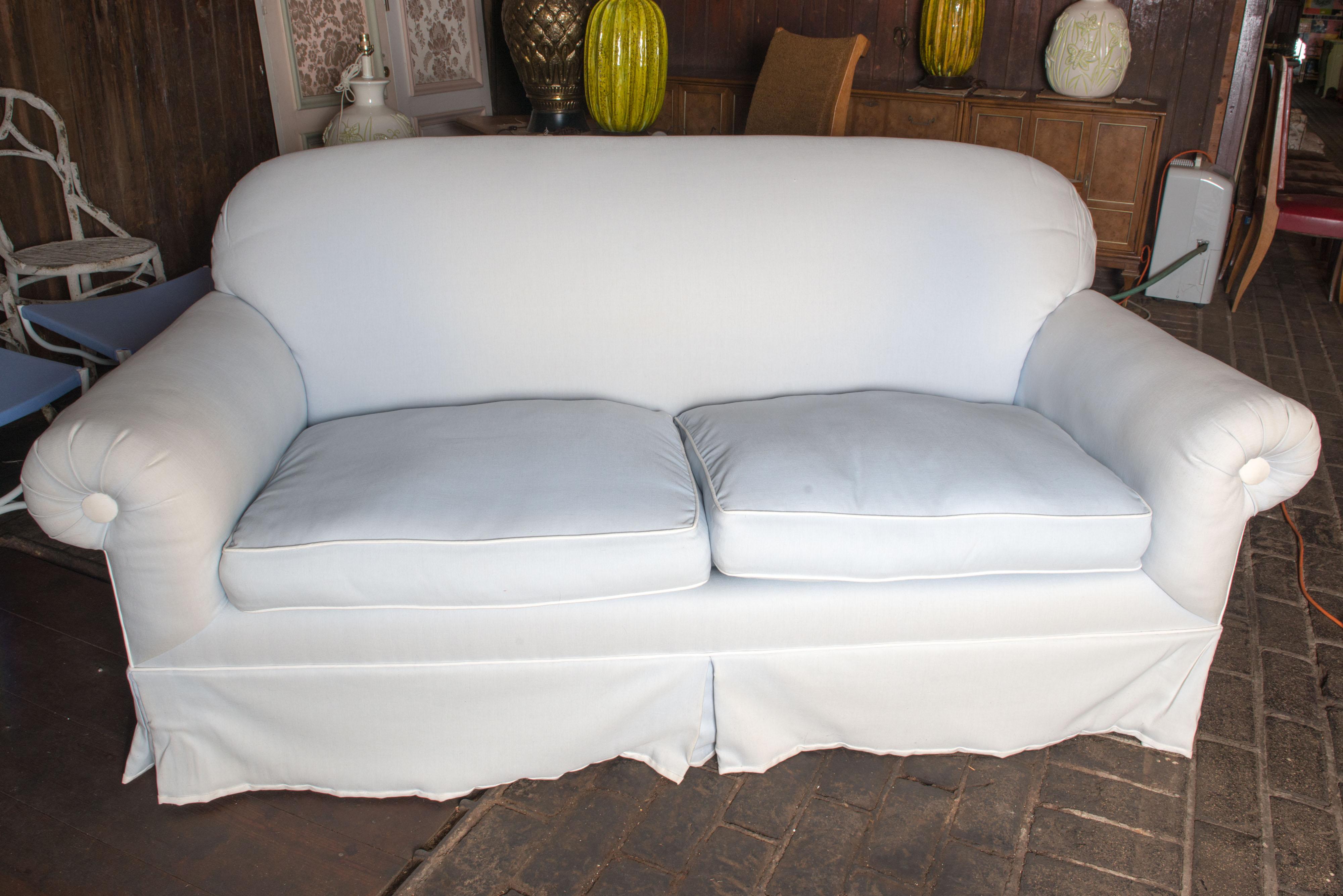Sturdy, hardwood 1950s vintage sofa upholstered in Jim Thompson Phuket, Haze Blue and trimmed in Phuket, White cotton. Fabric is intact but faded. Arm height is 26