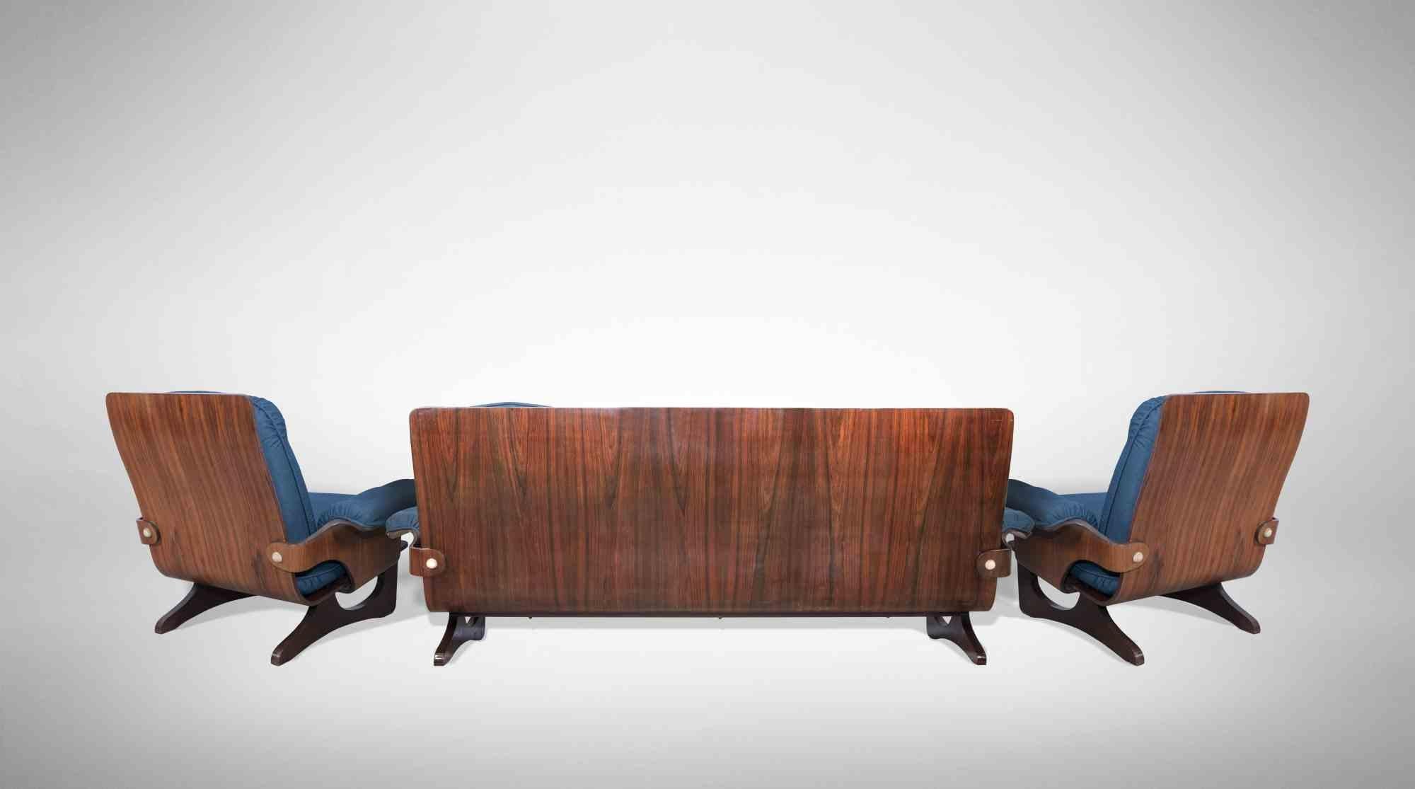 Vintage Sofa Set realized by Silvio Cavatorta in the Mid-20th century.

Top rare an impressive set of a sofa and a pair of armchairs realized in curved plywood veneered in rosewood and fabric.

Dimension of armchair: 75 x 80 x 90