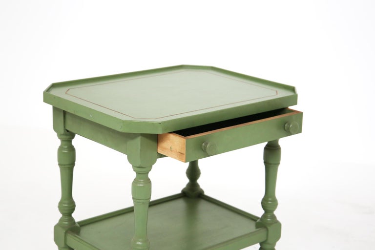Gorgeous vintage Italian made sofa table from the 1950's.
The sofa table was made of green lacquered wood, has a shelf at the bottom and a small drawer for objects that can be opened through a knob also made of wood. The conditions of the table are