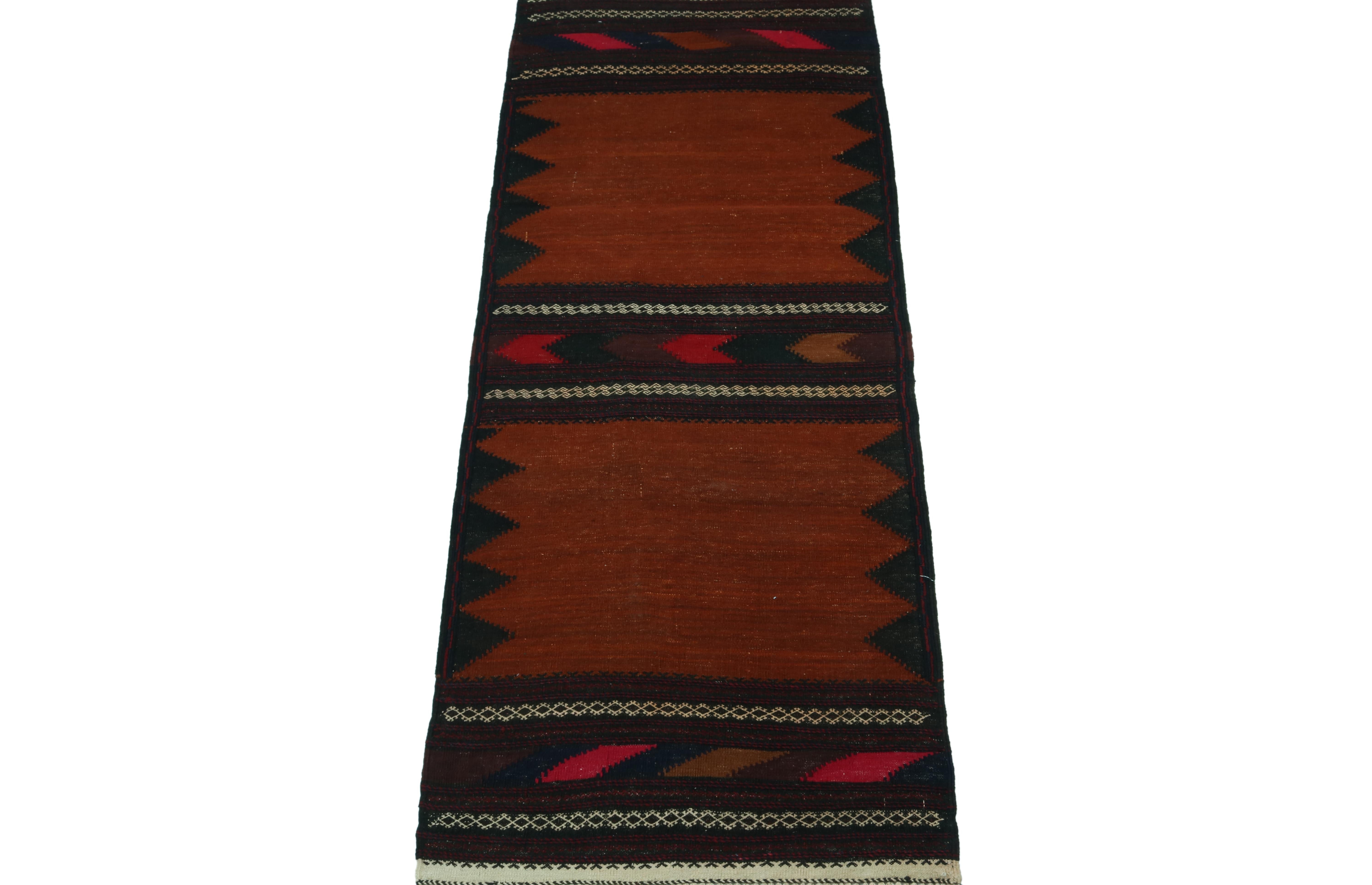 This vintage 2x5 Persian Kilim is a tribal rug of Sofreh provenance—handwoven in wool circa 1970-1980.

Further on the design:

This piece employs an open field style in rich chocolate brown and rust colors, as well as vibrant geometric patterns