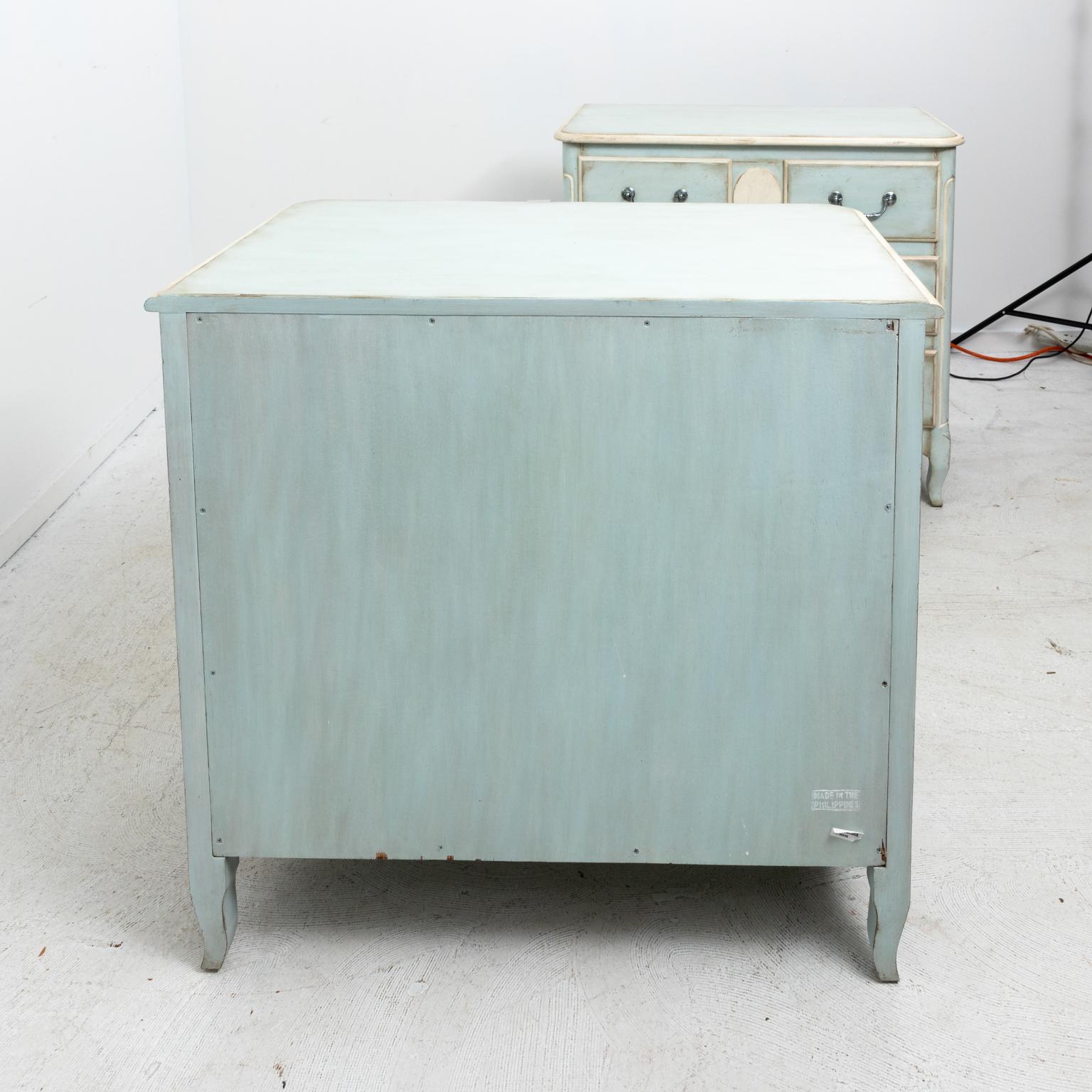 Pair of vintage Swedish style soft blue painted commodes or dressers, circa 20th century. The pieces also feature cream painted accents adorned with decorative silver pulls. Please note of wear consistent with age including minor paint loss and