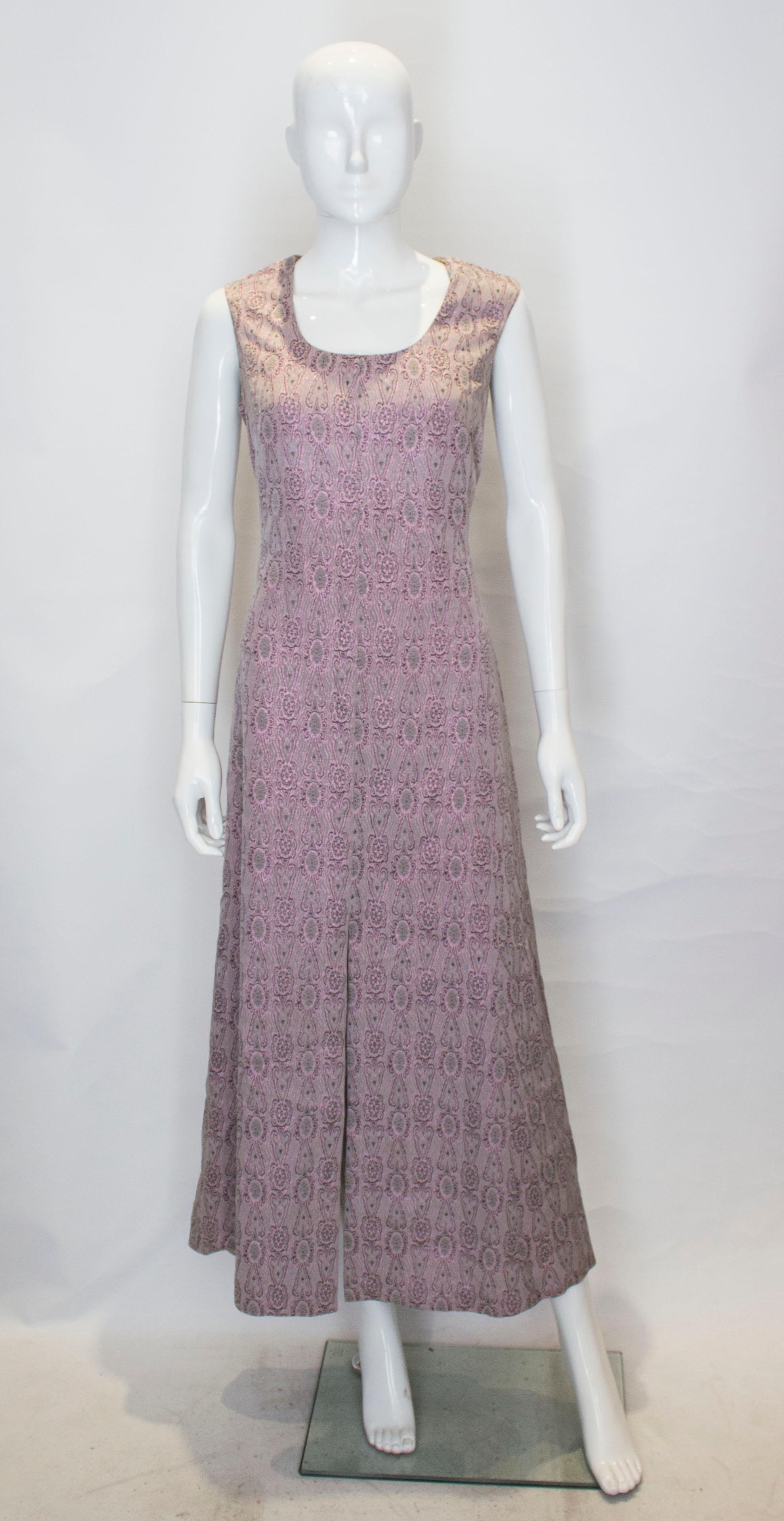 A pretty dusty pink /grey evening gown . The dress has a scoop neckline and backline, and has a side zip opening . There is a 21'' slit at the front.