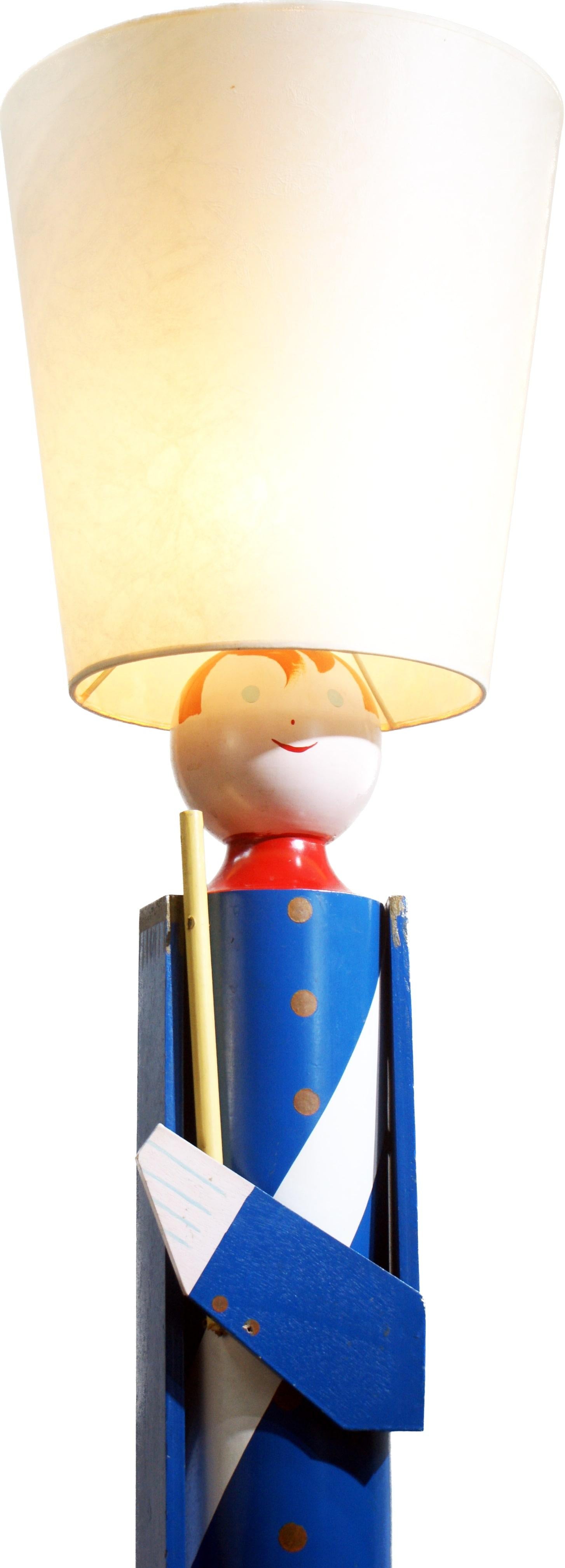 A 160 cm standing soldier with quite a style made in the late 20th century by Suzanne Bonnichon for Jacques Adnet. It is hand painted and lacquered. The colours red and blue are so bright and the style of this floor lamp is perfect for a child’s