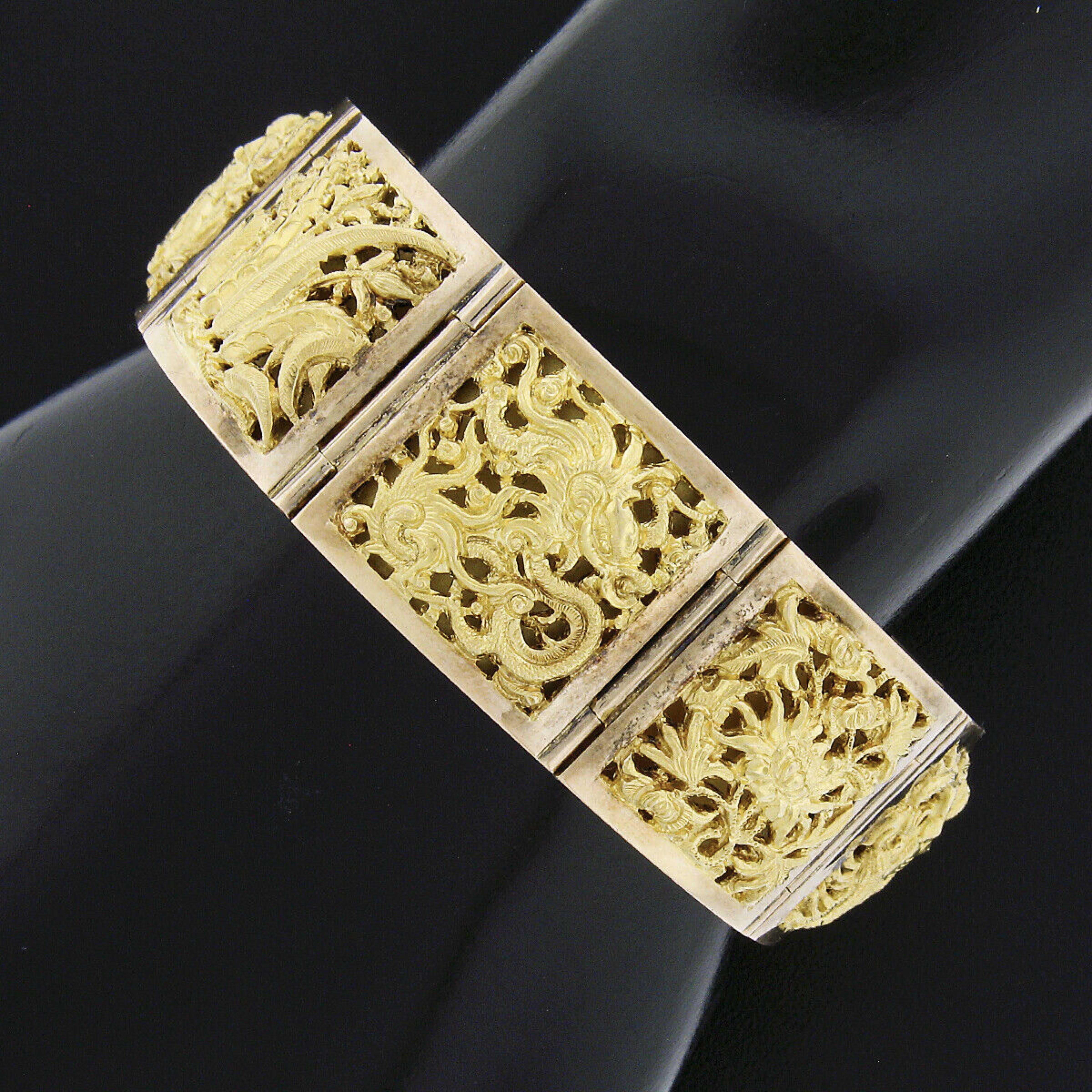 This absolutely stunning vintage bracelet was crafted from solid 18k yellow gold and features 8 intricately pierced panels with a nautical theme. The hinges between the panels are nice and tight indicating that the bracelet was likely barely worn.