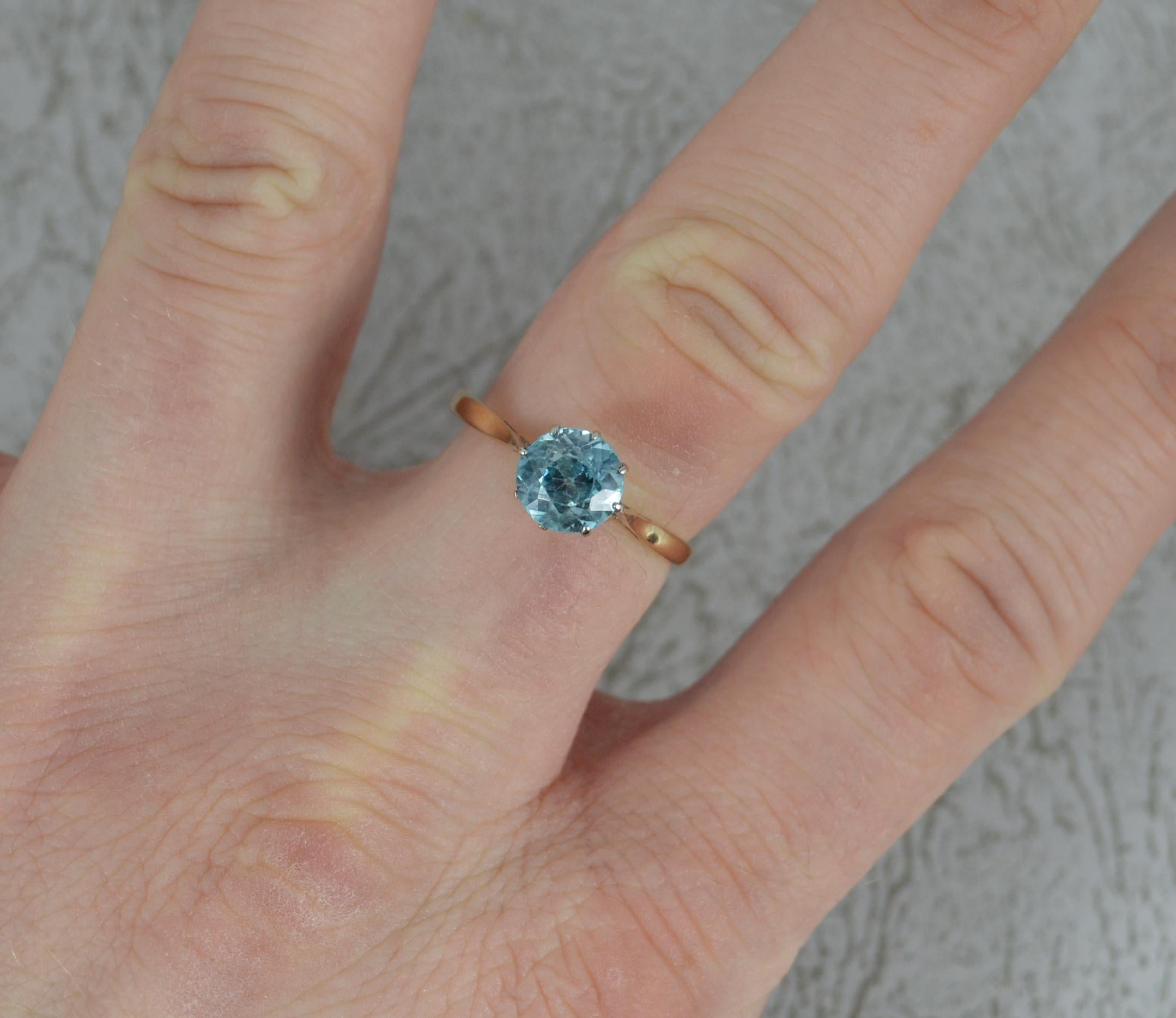 
A fine vintage solitaire ring. Claw set blue zircon. Solid 9 carat gold.

6.9mm diameter zircon to centre. 1.7 grams.

Size Q UK, 8 US.

Clean shank. Securely set stone, some claws worn than others. Light general wear to edges and facet edges.