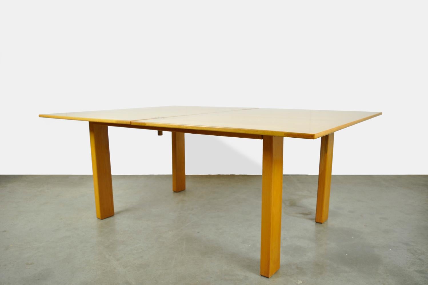 vintage solid beech folding 4-6 seater dining table produced by Ibisco, 1970s Italy. The table has an ingenious system of enlargement. The blade is rotated 90 degrees and then unfolded. In this way a twice as large leaf is created for 6-8 persons.