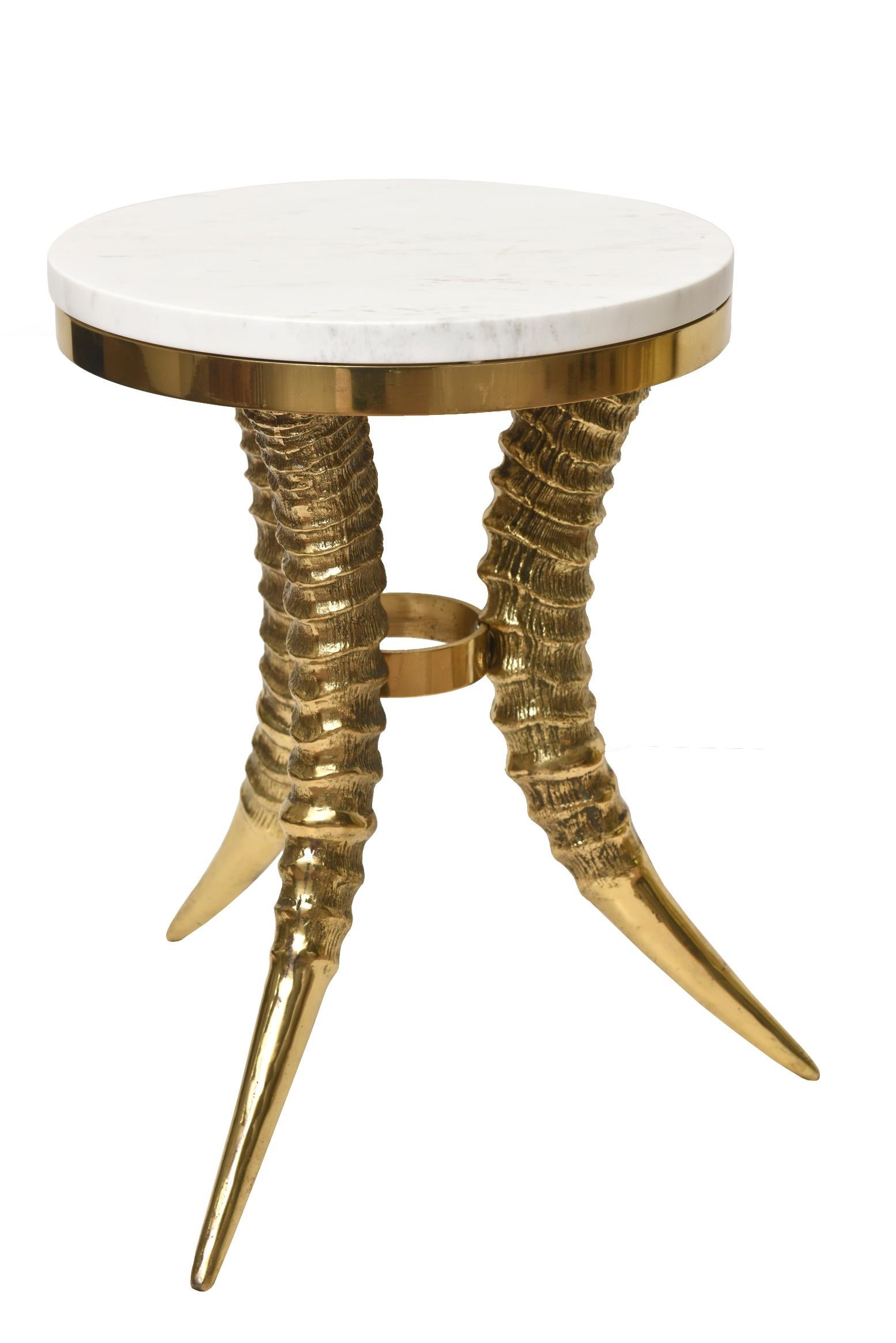 This fantastic vintage and solid brass horn side or drink table with a marble top is tres chic! The marble top was replaced and is called Volakas marble from Greece. It has beautiful veining of gray and champagne with white. It is sculptural and