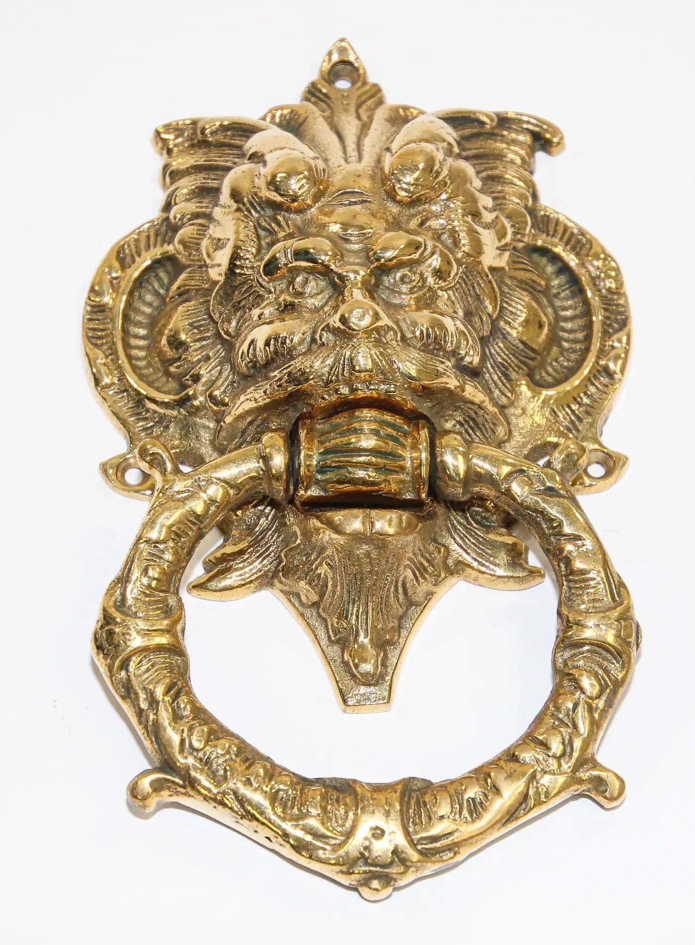 Vintage solid cast brass Italian door knocker with scary evil devil man face. The large mascaron crest has been crafted in grotesque style and is sometimes called a chimera. A mascaron is an architectural ornamentation, typically a face, that is