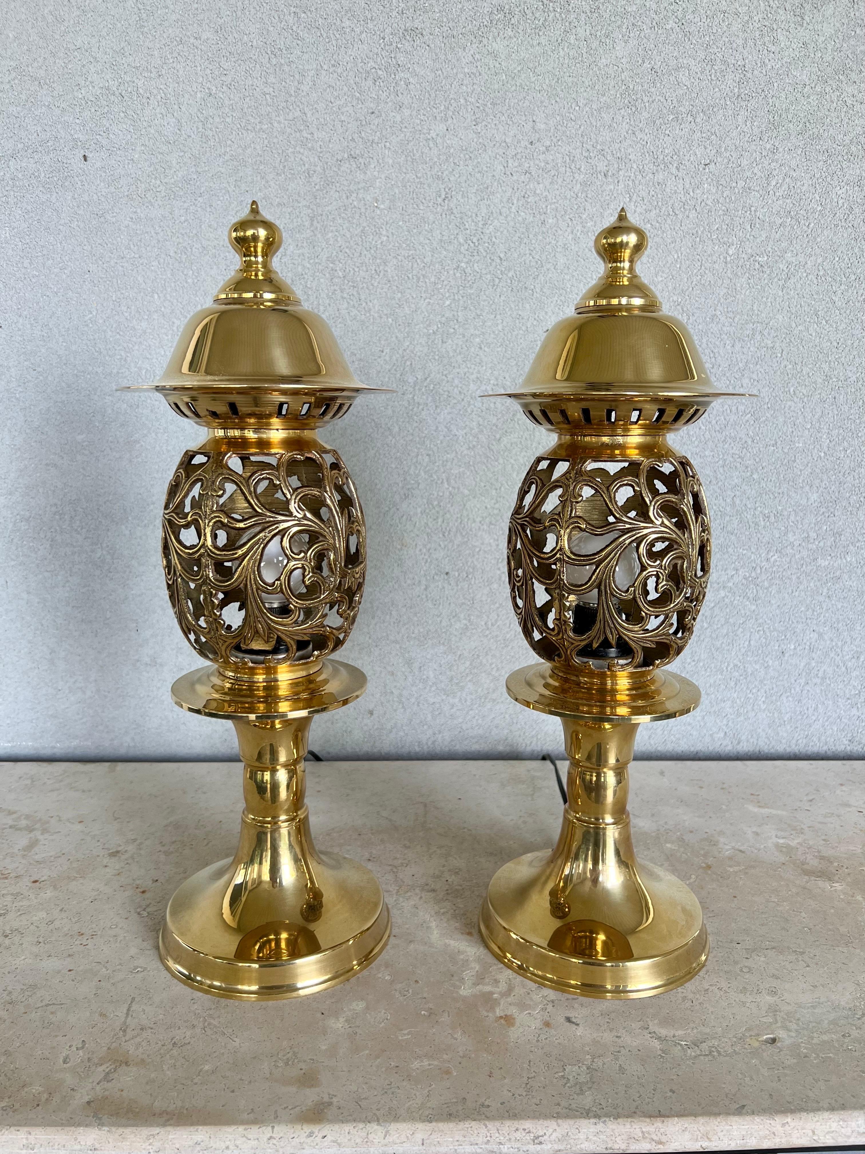 Enhance your living space with these exquisite solid brass Moroccan scroll table lamps. Crafted with precision, each lamp showcases an elaborate scrollwork design that is both intricate and airy, allowing for a play of light and shadow that will add