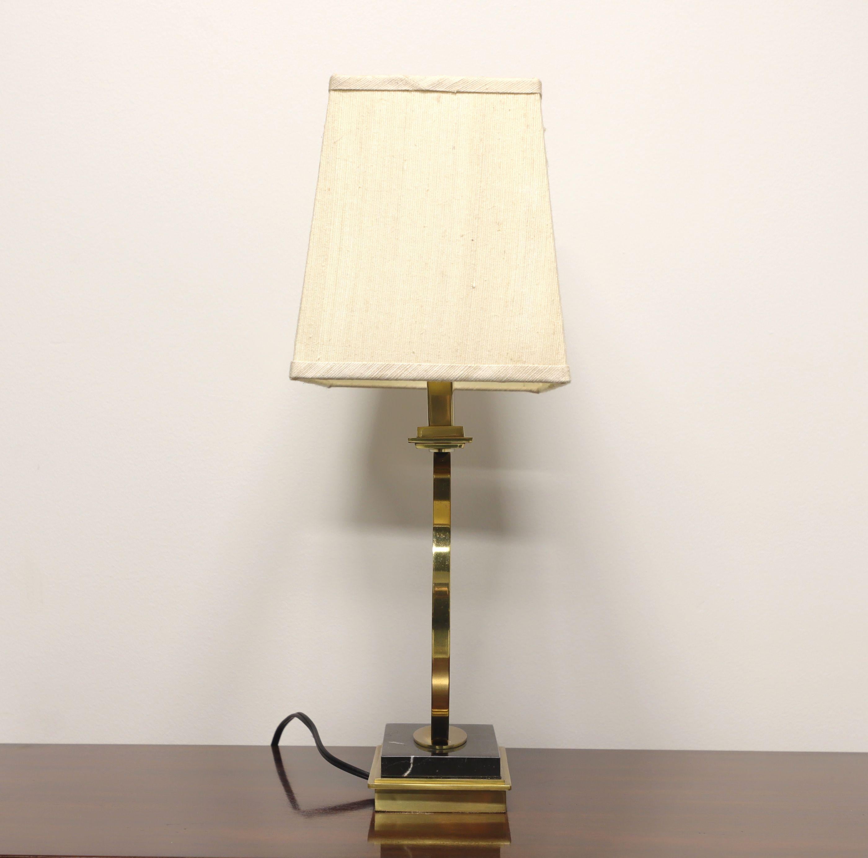 A Contemporary Modern style table lamp, unbranded. Solid brass in a circular design with a marble on brass base. Single standard bulb socket and 3-way rotary switch. Includes rectangular fabric shade.

Measures: 15.25 W 8.25 D, Base to Finial: 23 H,