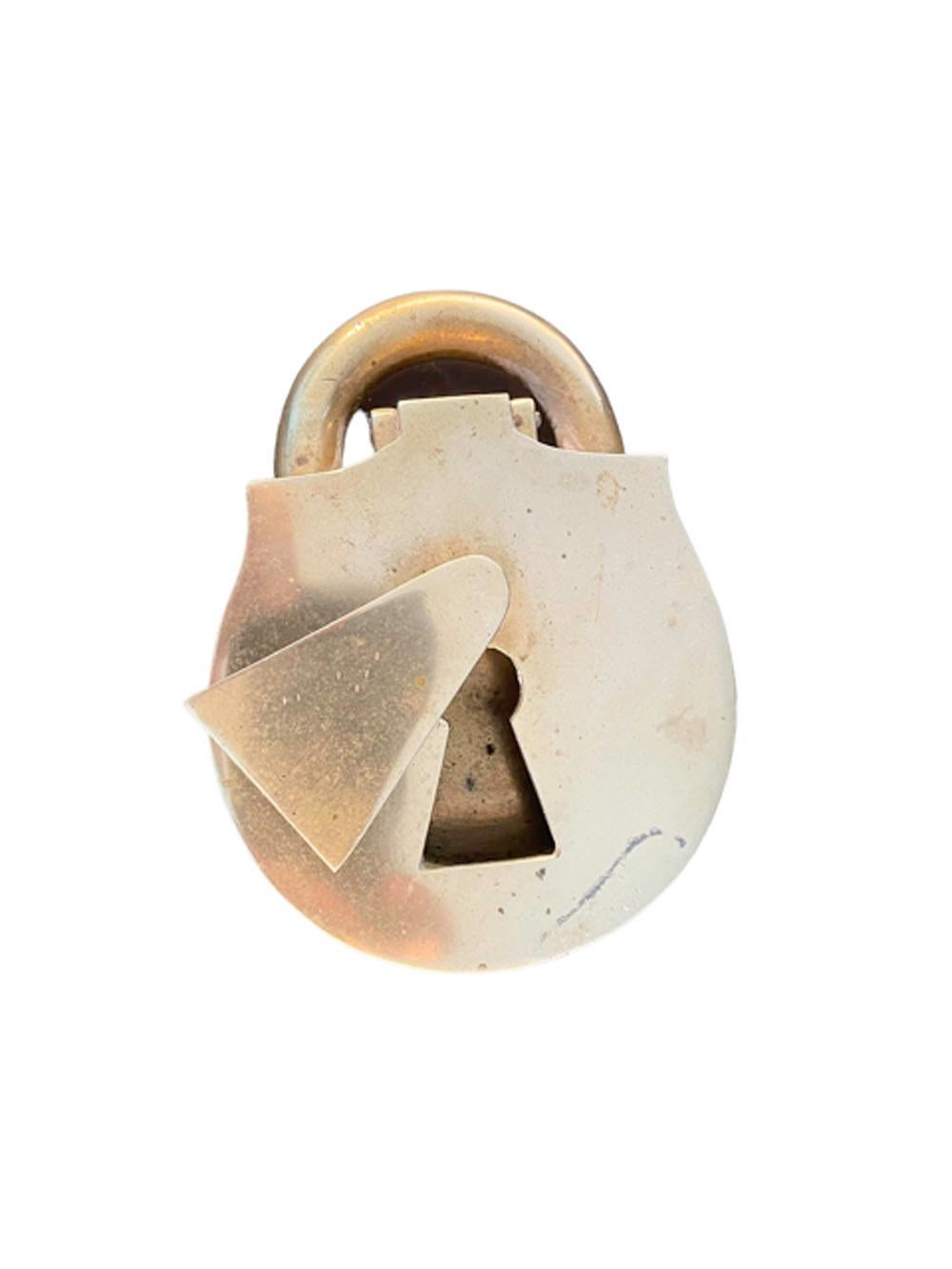 Vintage solid cast brass ashtray made in the form of a padlock. the hinged front (top) with a pivoting keyhole cover opens to reveal the ash bowl, the back of the keyhole cover id marked 
