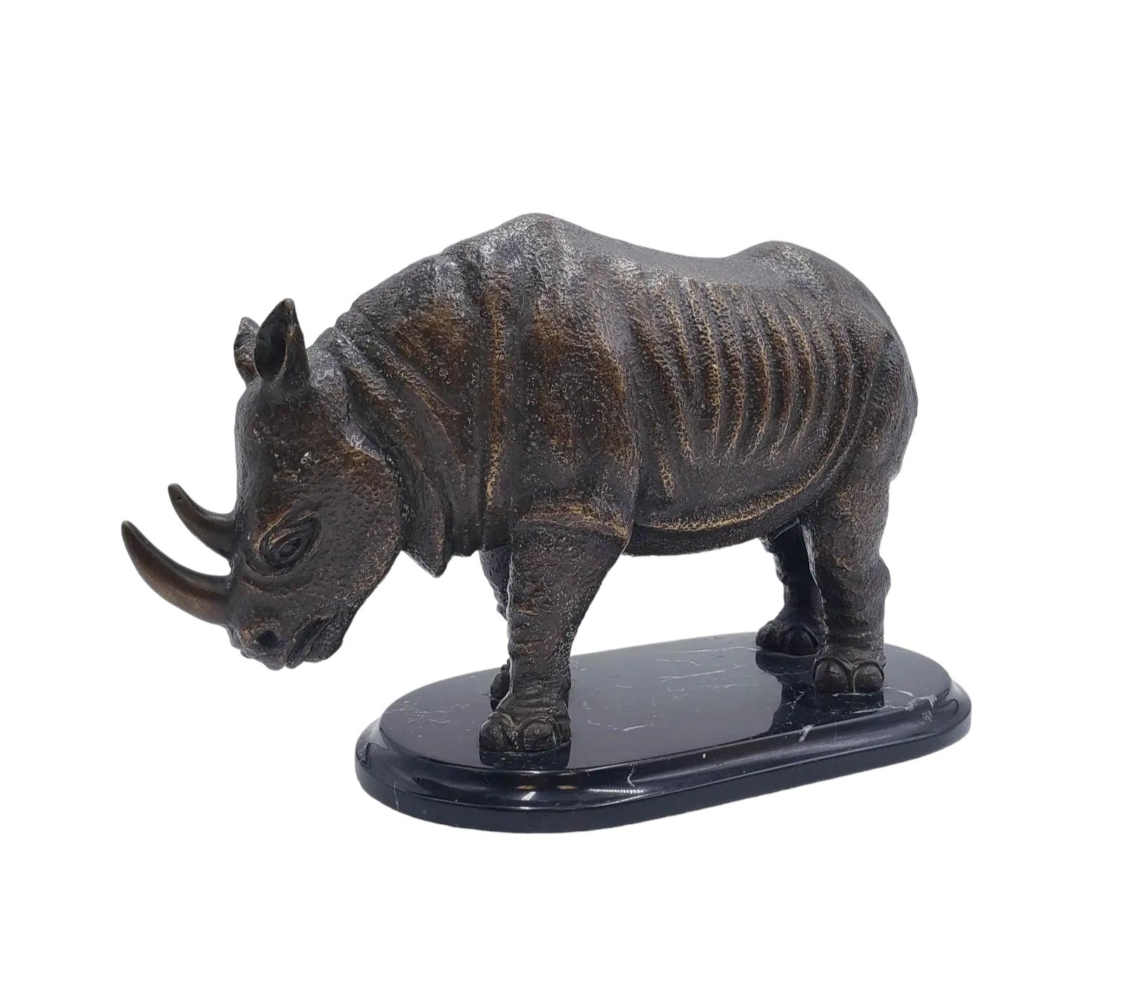 Questa scultura vintage di rinoceronte in bronzo fuso massiccio, che domina l'attenzione con la sua potente presenza, è una testimonianza del fascino duraturo dell'arte animale. Sapientemente resa con dettagli realistici, la pelle robusta e le forme