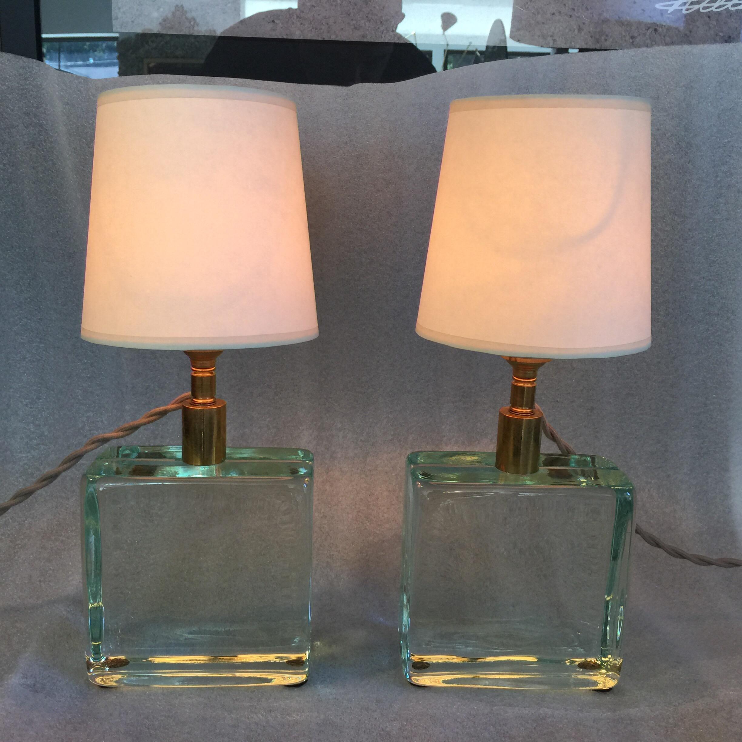 In the manner of Fontana Arte, these Italian petite solid glass brick lamps are finished with vintage natural paper shades. Newly rewired for US with silk cable. They are fun!

Note: We kept the original Bayonet European sockets, light bulbs can