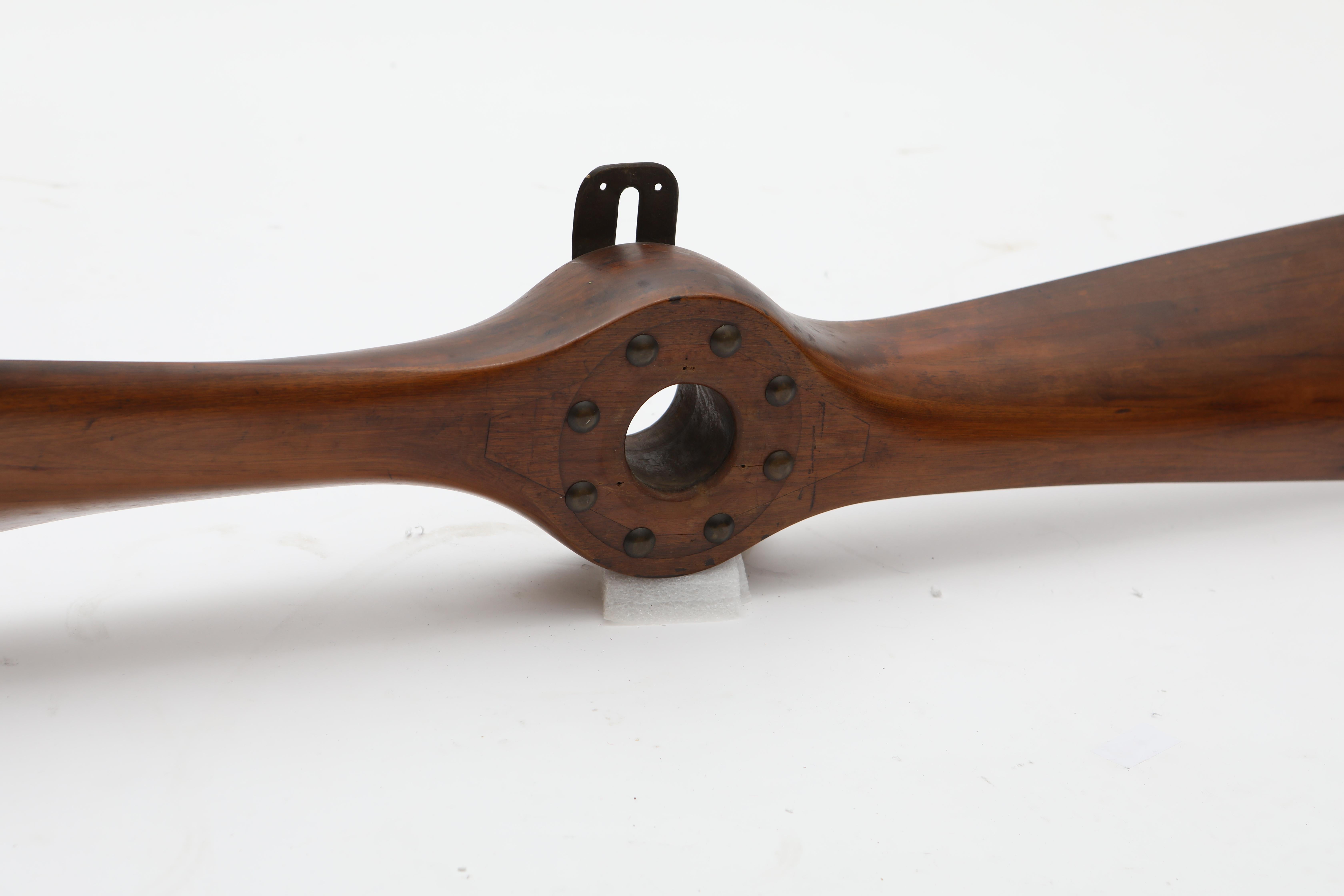 Decorative vintage aircraft propeller, elegantly crafted from solid mahogany.
Features a natural, age-related patina that adds to its character.
Believed to originate from an English aircraft, circa 1920-1930.

Dimensions: L 230 cm  W 23 cm  D 10.5