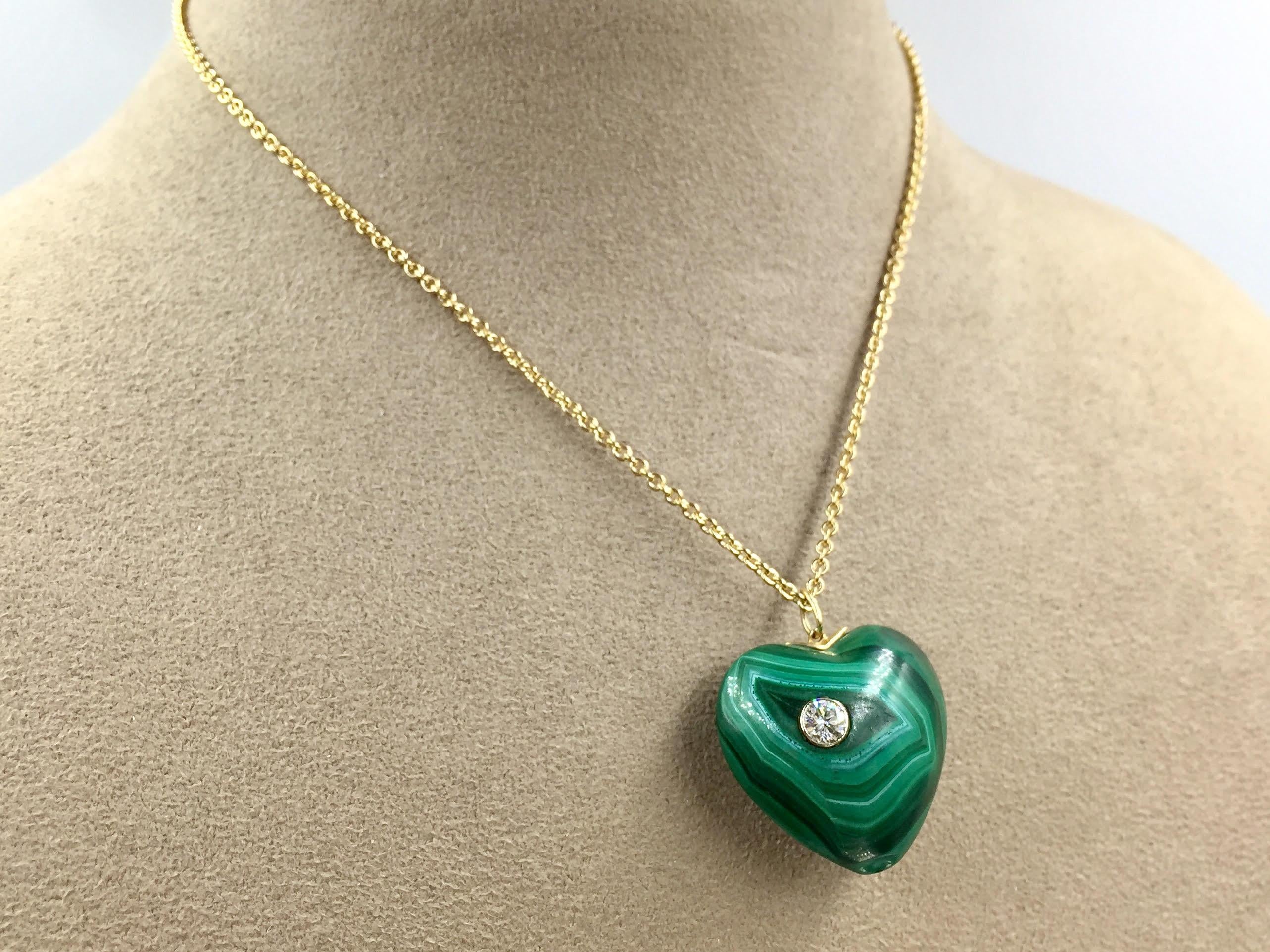 Circa 1970. A beautiful, large piece of genuine malachite is carved into a heart and features one burnish-set round brilliant diamond. The diamond is approximately .30 carats, G color, VS2 clarity. The pendant comes with a 15