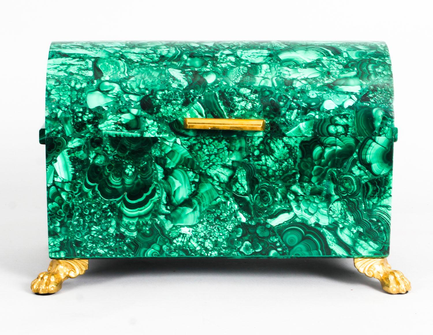 This is a superb quality domed malachite casket dating from the second half of the 20th century.

Decorated and raised on fabulous gilt bronze ormolu claw feet with an ormolu handle.

Made from solid malachite and in really superb