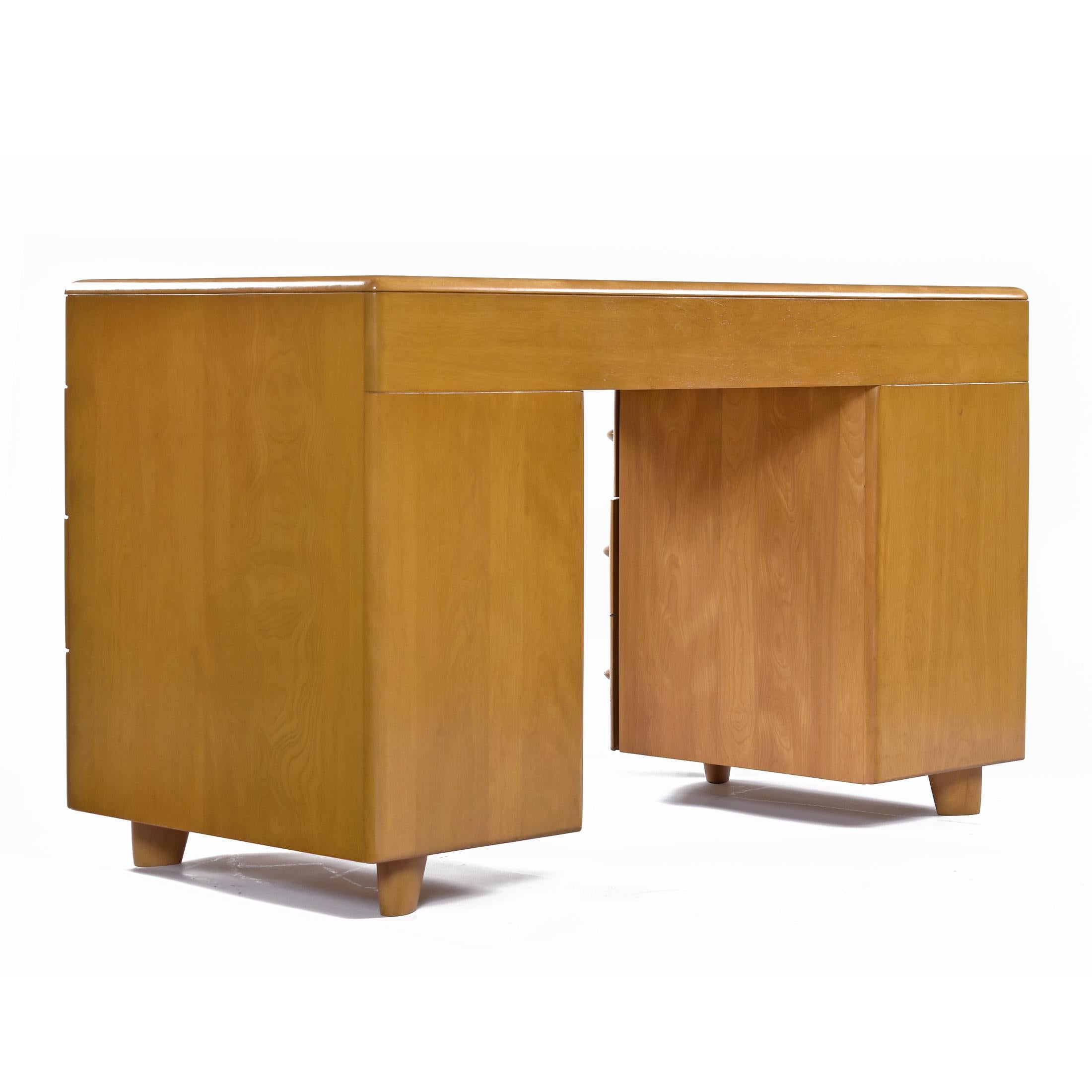 This listing includes both the desk and chair.  

Collectors know that it is difficult to find original Heywood in good condition.  The desk top has been refinished to match original specs in Heywood Wakefield wheat. This sleek, study, understated