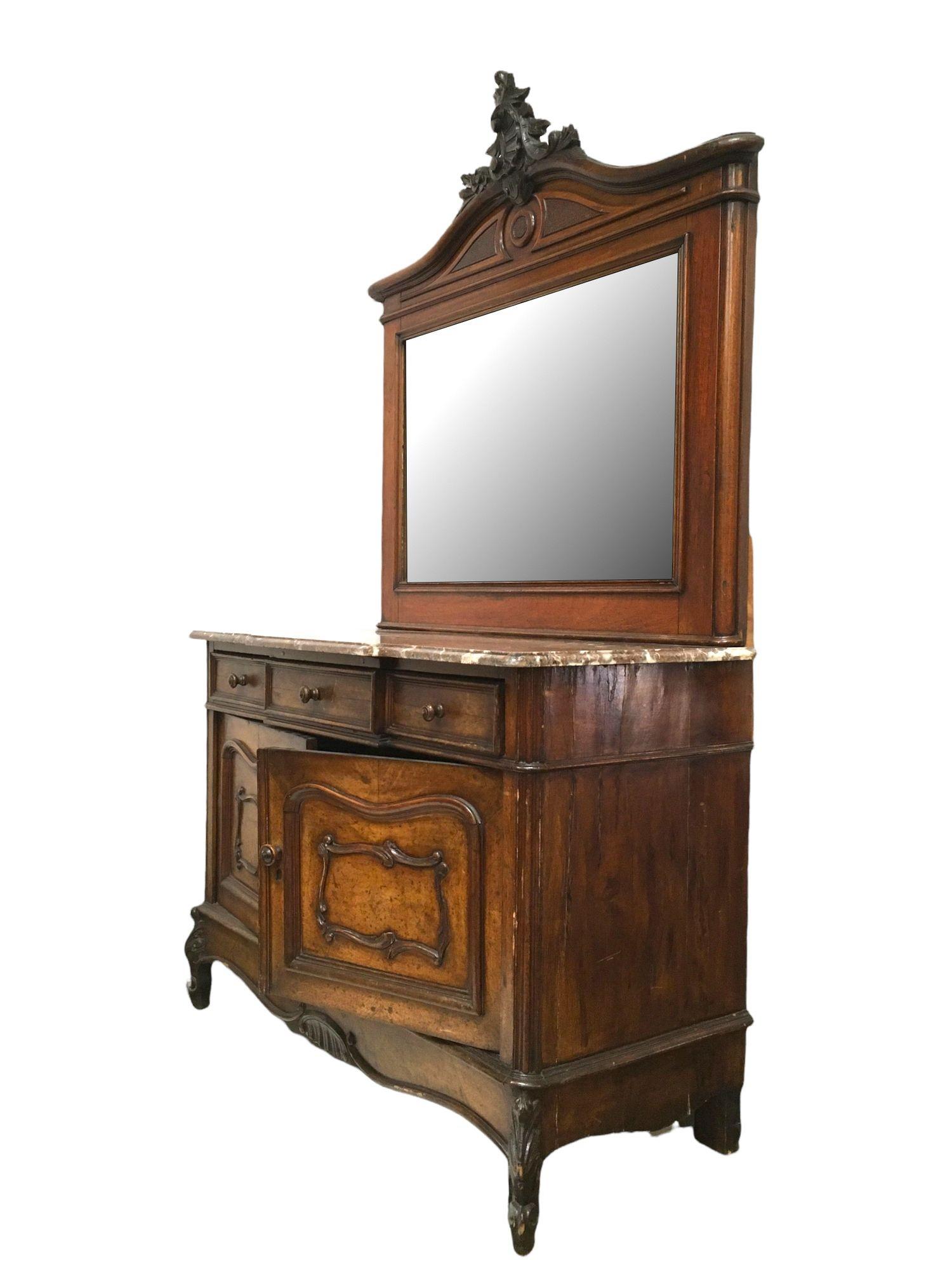 Vintage Solid Oak Dressing Table / Vanity with Marble Top
 
This solid oak piece of furniture can serve as either a dressing or a vanity table. Featuring gorgeous carvings throughout and a nice mirror with beveled edges. Its marble top has a