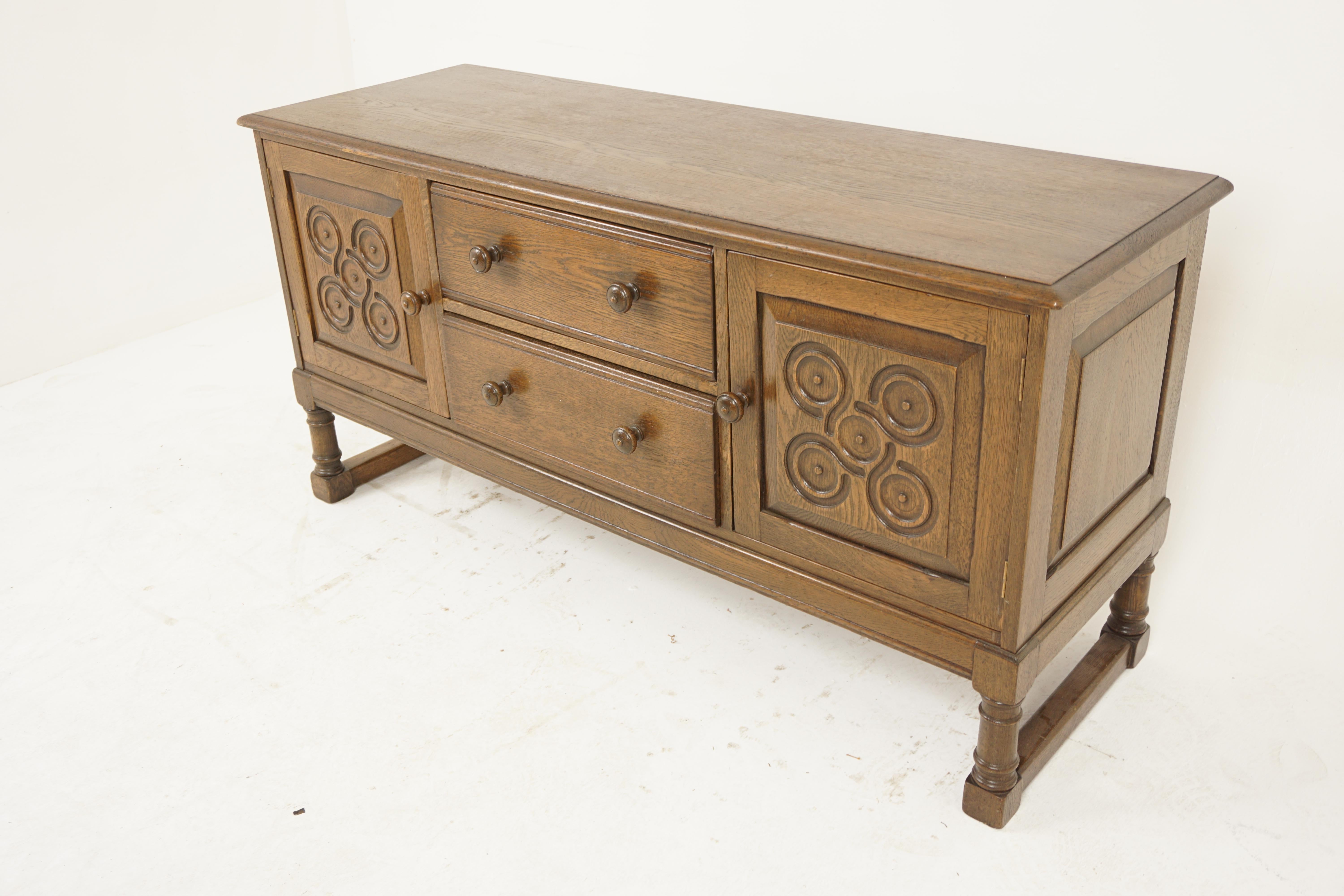 Vintage Solid Oak Sideboard, Dresser, Buffet, Scotland 1930, H1157

Solid oak
Original finish
Rectangular top with moulded edge
Pair of dovetailed drawers with original wooden knobs
Flanked by a pair of carved doors that open to reveal single shelf