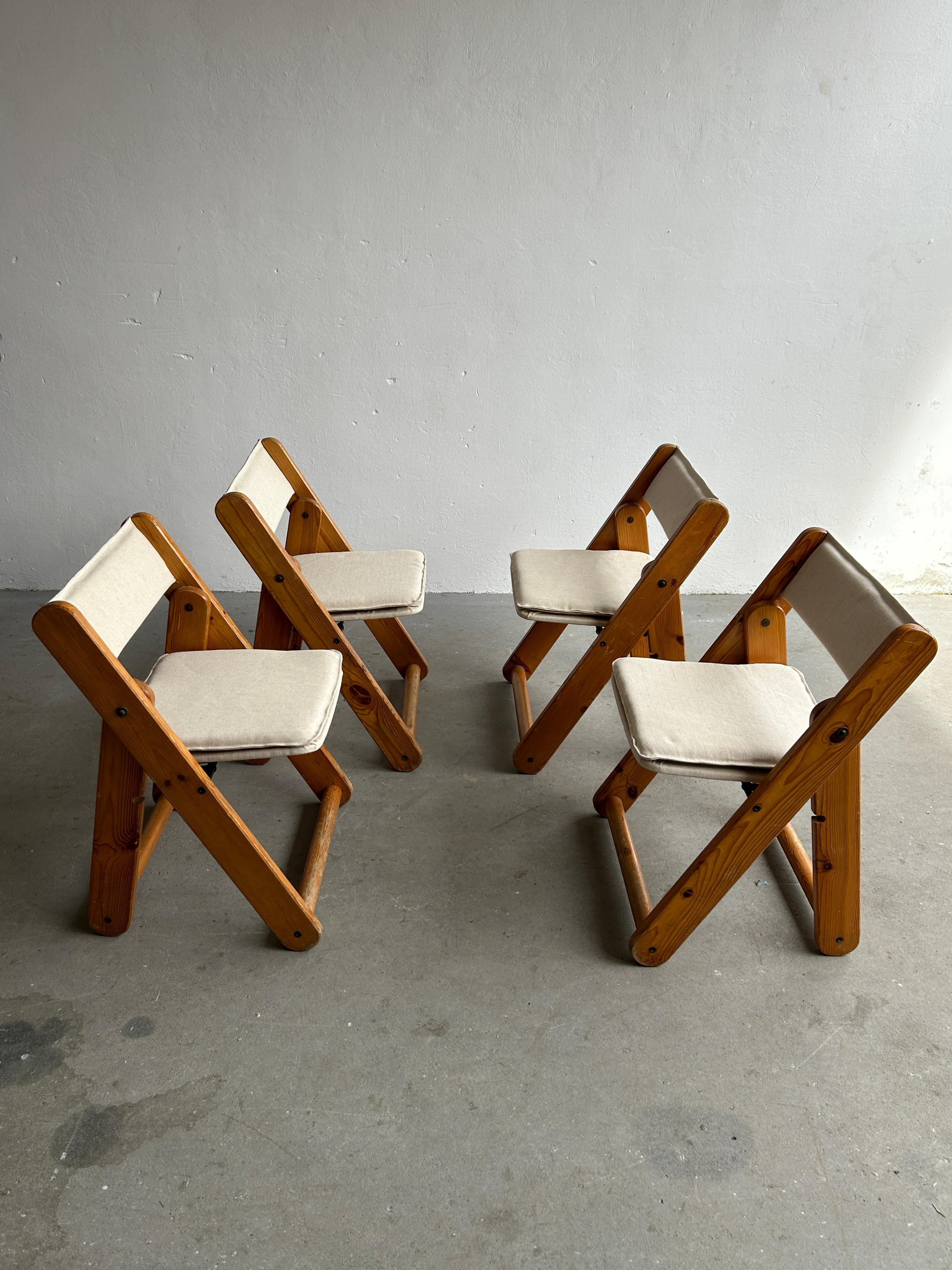 Set of four solid pine and canvas folding chairs designed by Gillis Lundgren for IKEA, 1970s.

Good vintage condition with expected signs of age. Authentically aged wood. Surface scratches and scuffs are present, as indicated in the photos.