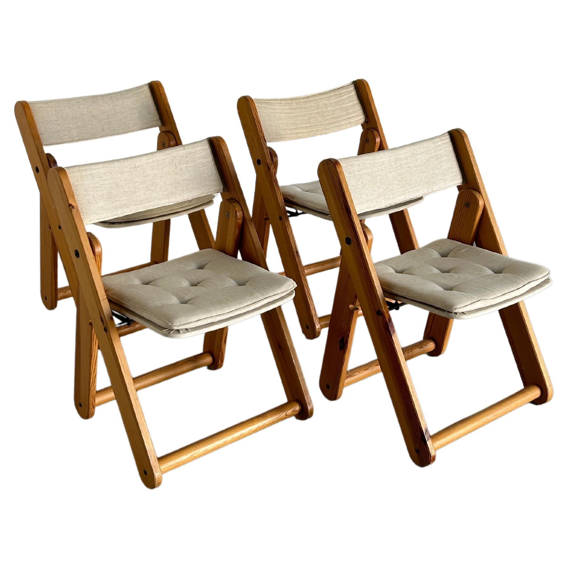 Set of four solid pine and canvas folding chairs designed by Gillis Lundgren for IKEA, 1970s.

Very good original vintage condition with expected signs of age. Authentically aged wood. Smaller surface scratches and scuffs are present, as indicated