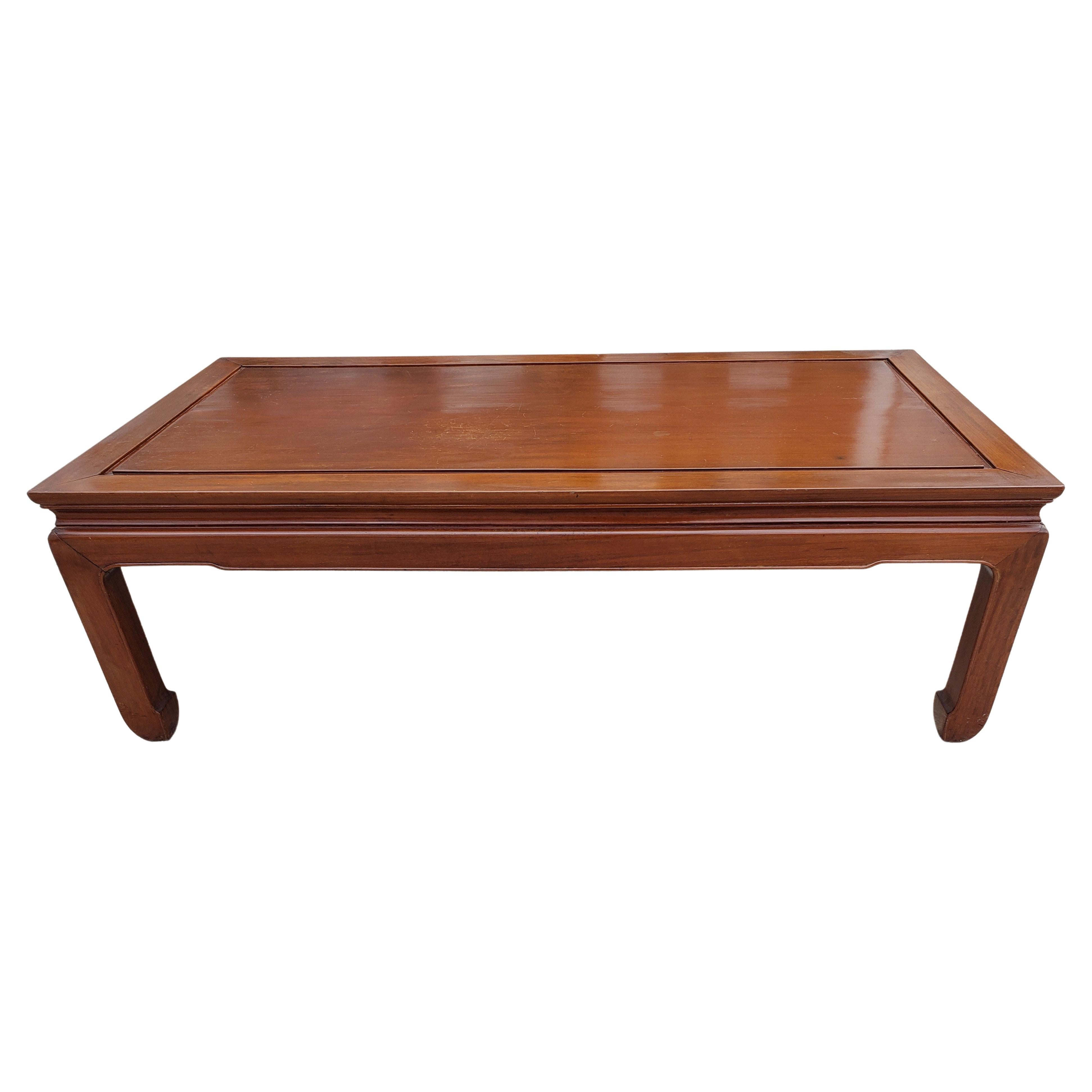 This a very solid rosewood in Ming style coffee table. Simple clean lines, Asian key design on the edges. Hand-applied natural rosewood finish enhances the beauty of the wood grains. This amazing table is made in the 50s era. It's all hand-built