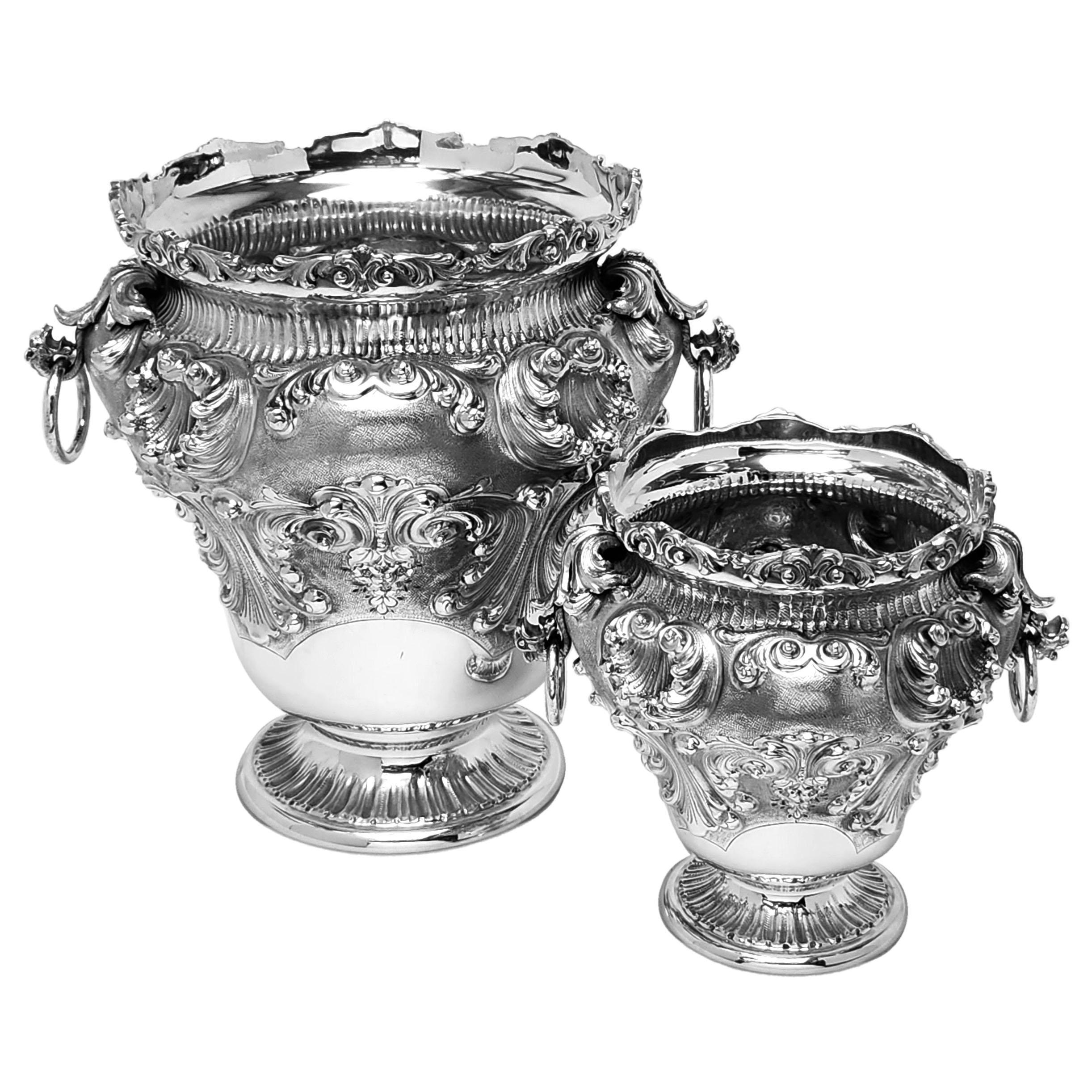 An elegant Italian Solid Silver Set comprising of a Champagne / Wine Cooler and a matching Ice Bucket. The Set has a chased Rococo inspired Design and each has a pair of ring handles.  Each Cooler stands on a spread pedestal foot.

Made in Italy in