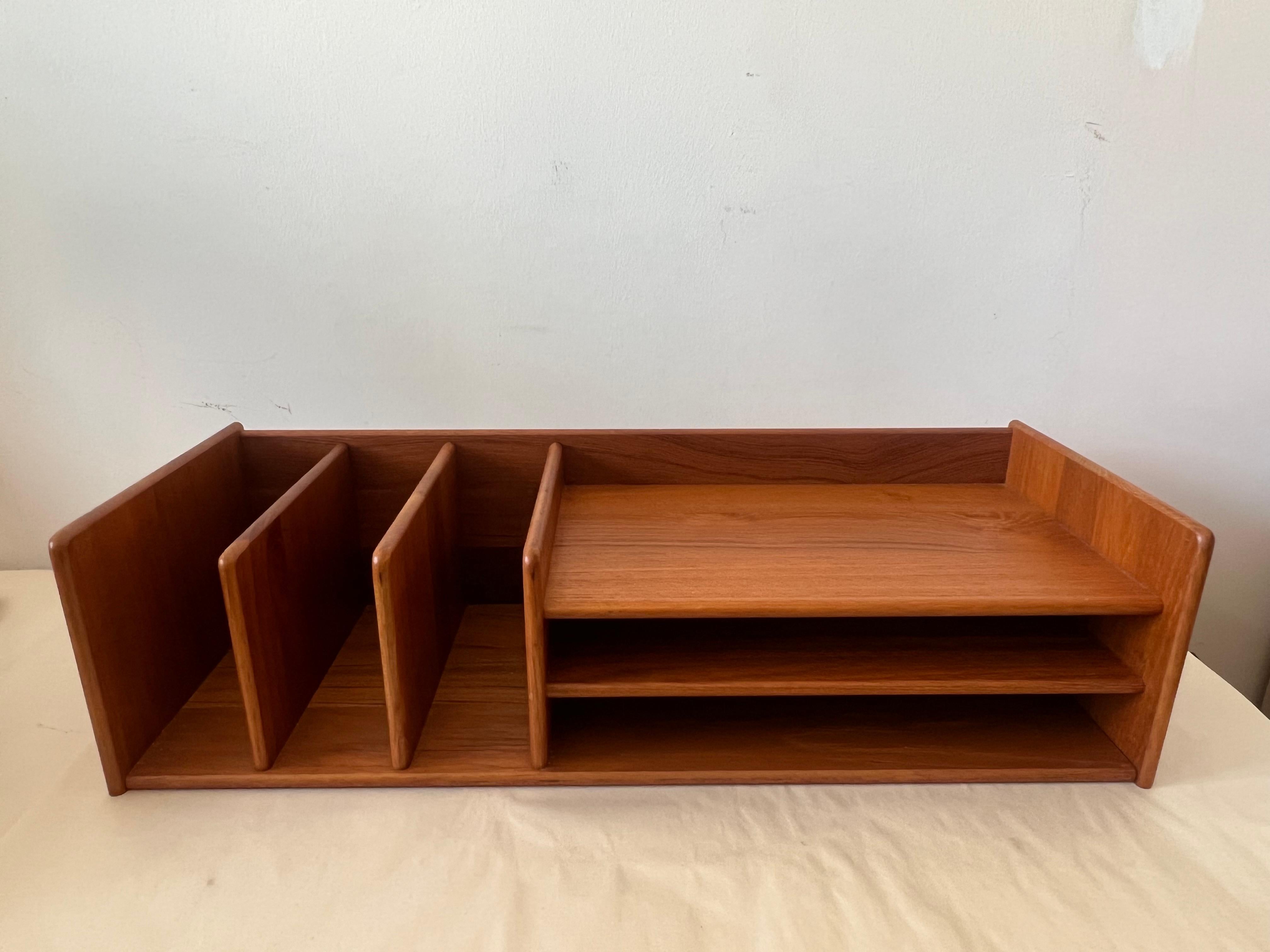 A classic Danish modern letter organizing tray in teak exported by Nordisk Andels-Eksport. This space saving desktop accessory is perfect for tidying up office supplies, books, documents, mail, and paperwork. Equipped with three vertical dividers