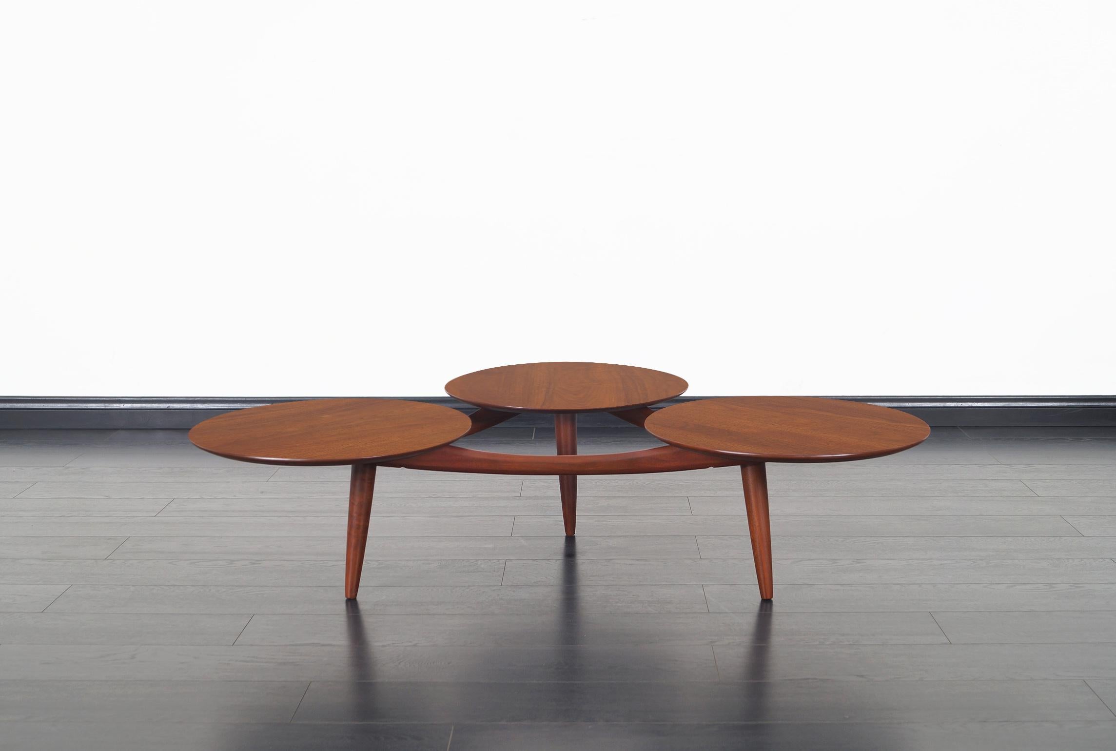 An amazing vintage solid walnut coffee table attributed to Greta Grossman. Features three circular floating tops on a solid walnut base. Manufacture by ACE-HI in Los Angeles, California for its Prelude collection.