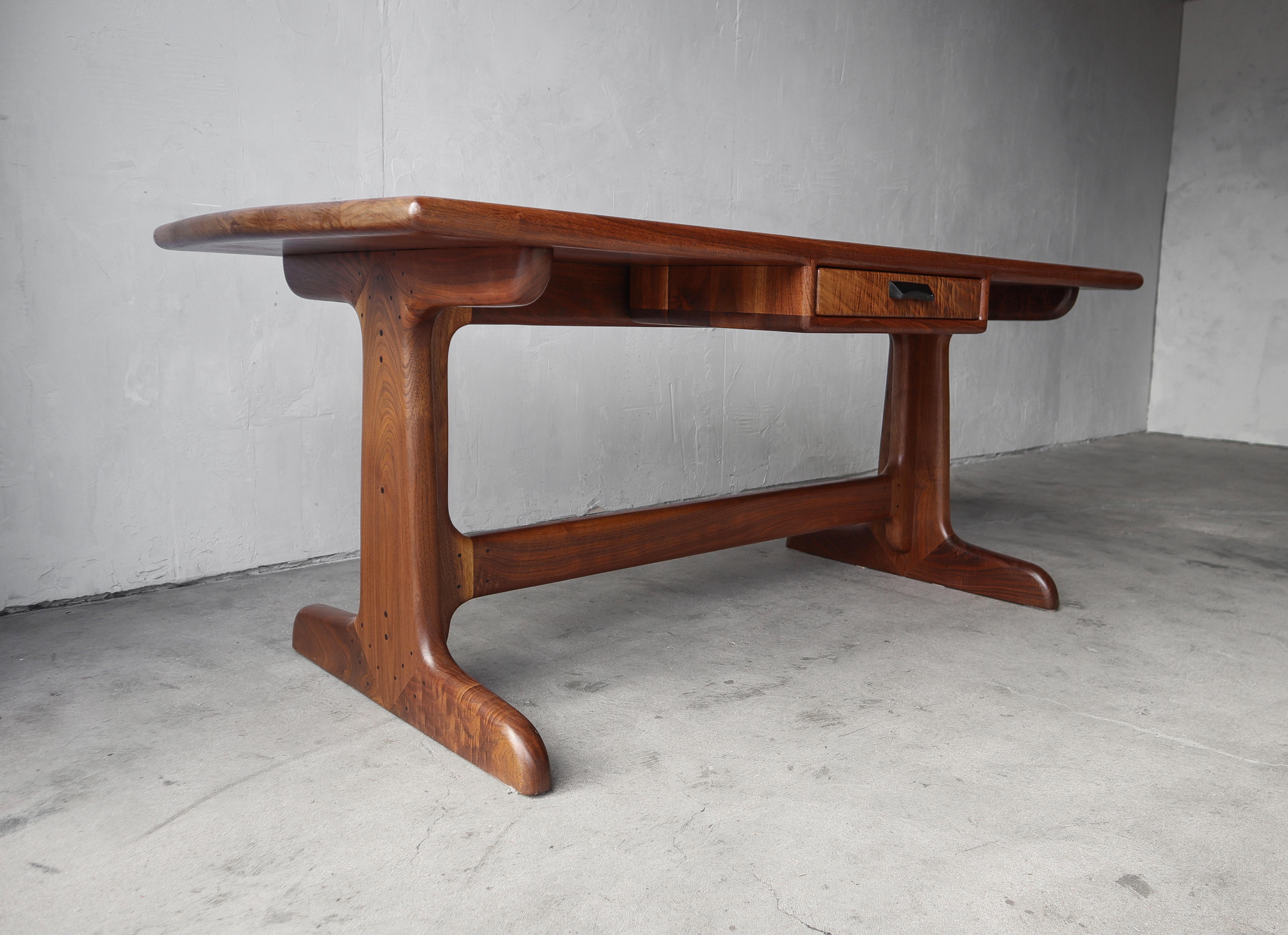 This beautiful Studio Craft partners desk is incredible. NO detail was overlooked in the making of this stunning piece, sculpted entirely of heavily grained, solid walnut, finished expertly, with seamless transitions and expert joinery.  The desk