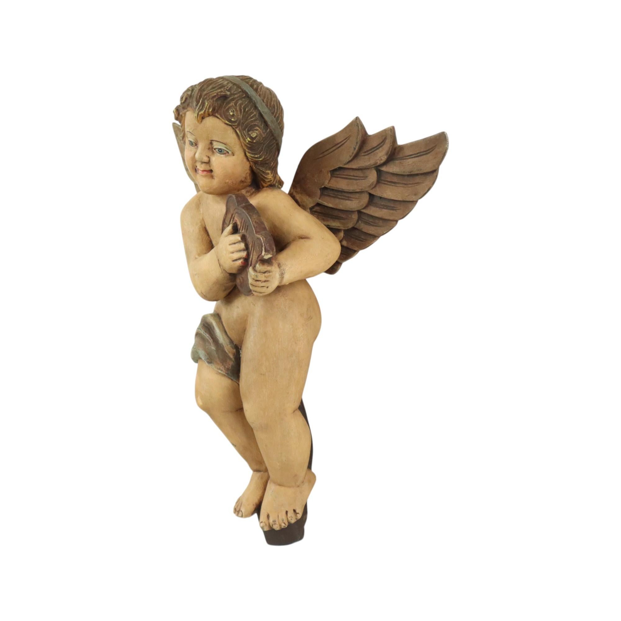 Beautiful vintage angel or cherub playing a harp, decorative object made of solid light wood and a fine layer of gesso, completely hand-painted, circa mid-20th century or earlier, Belgium.

This fantastically beautiful statue comes from an old