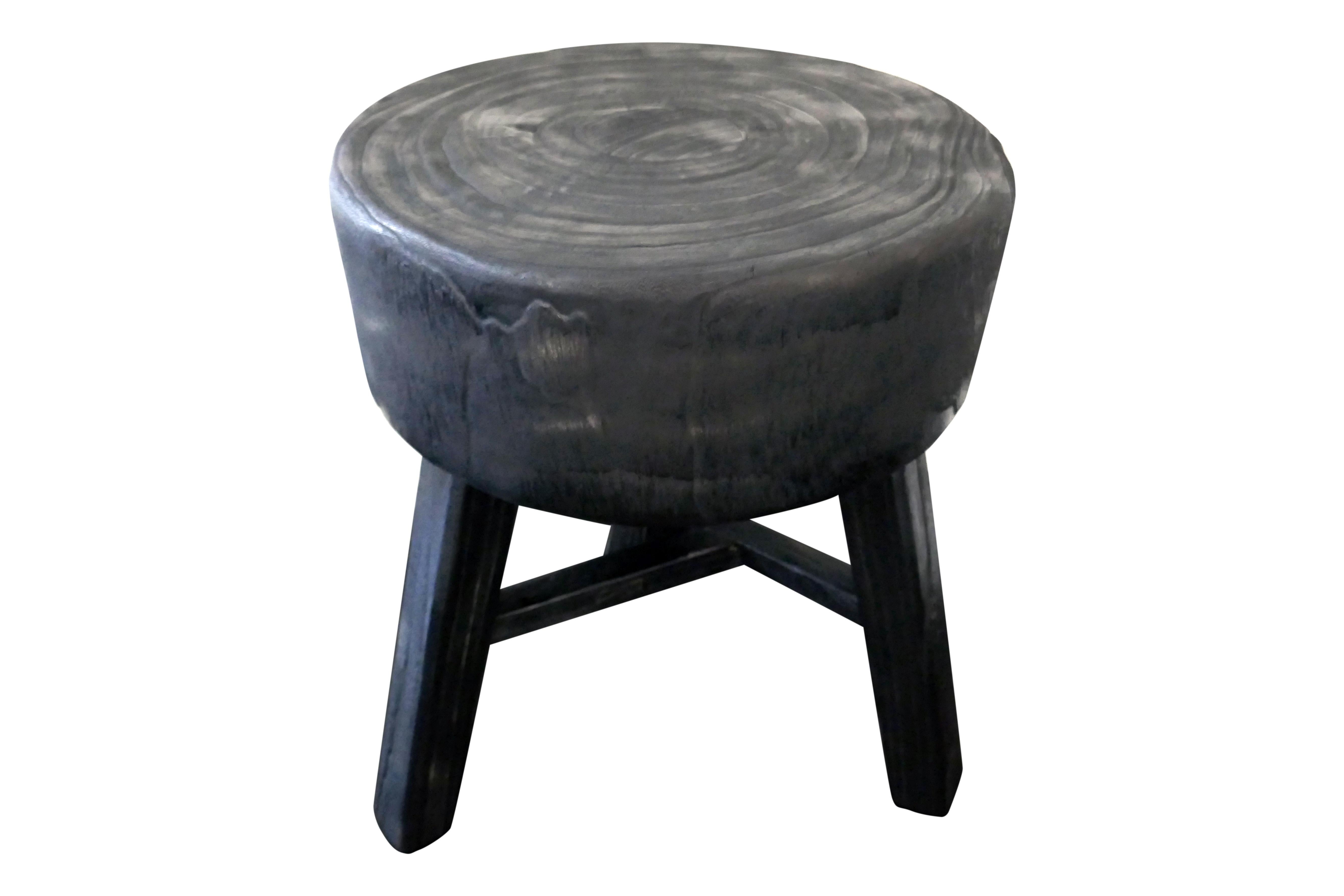 The perfect accent piece. This very versatile piece is primitively hand-carved from a solid piece of hardwood. Solidly built thick legs constructed by mortise & tenon joinery. Lightly distressed black finish.